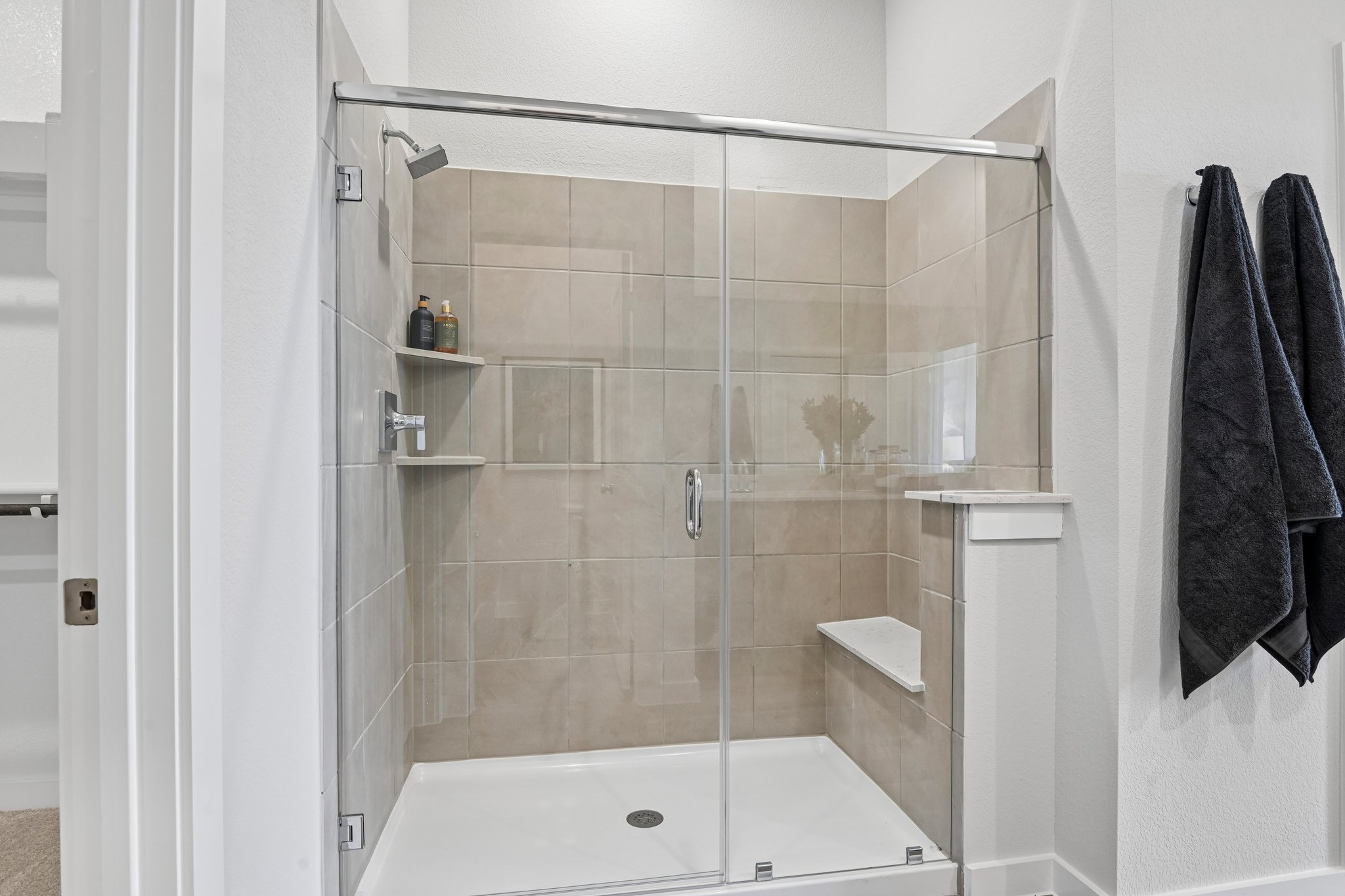 A shower with a glass door.