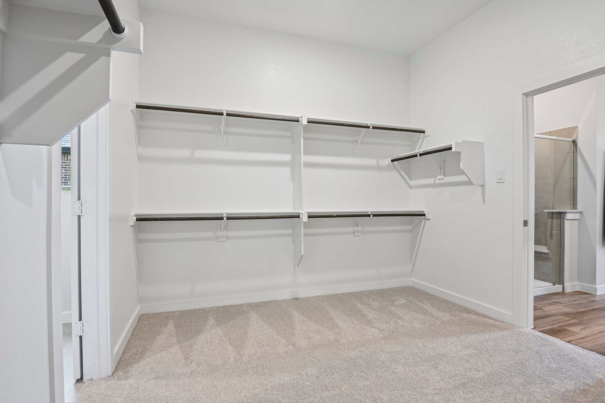 A white room with a glass door.