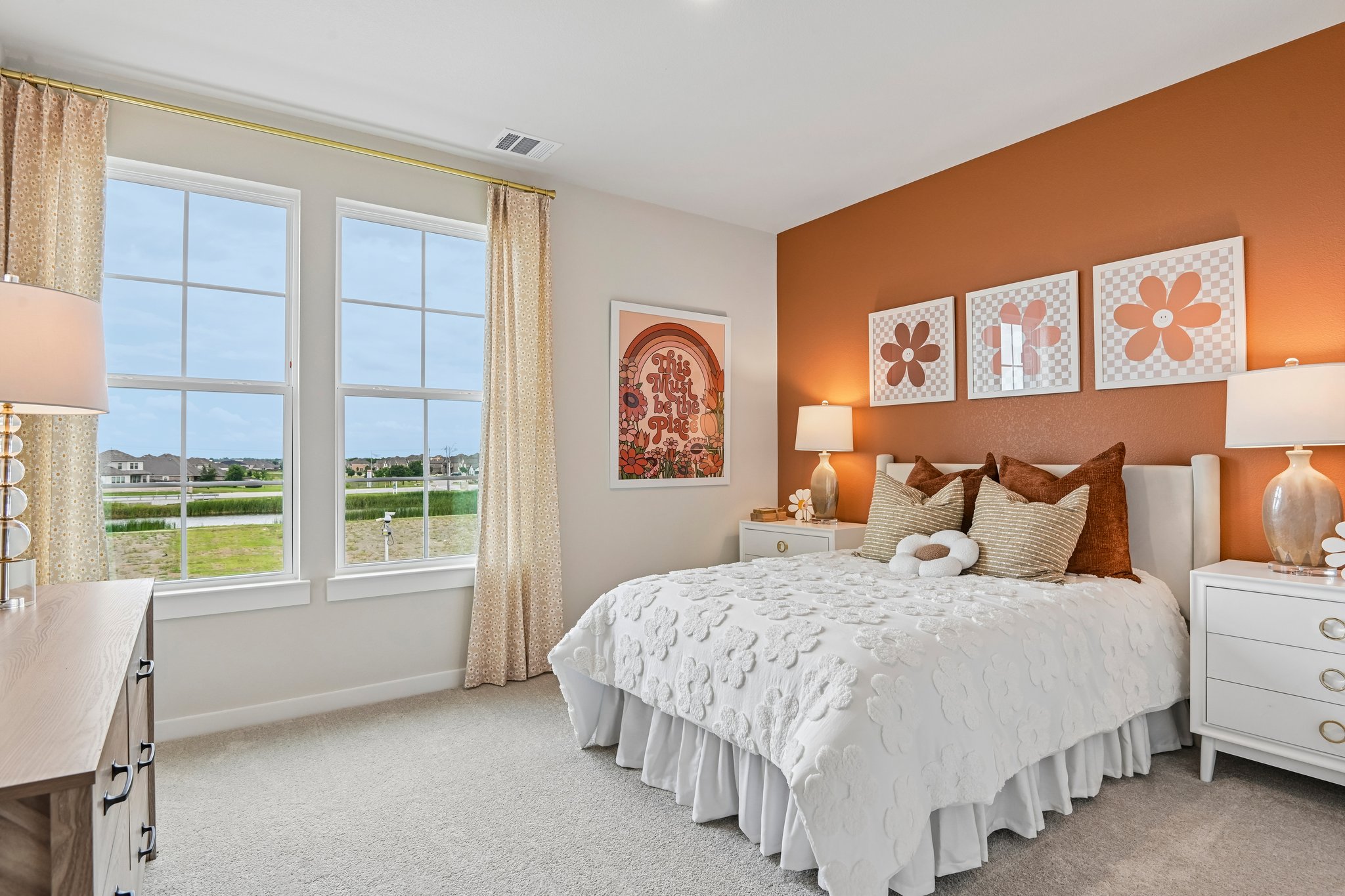 A bedroom with a large window.
