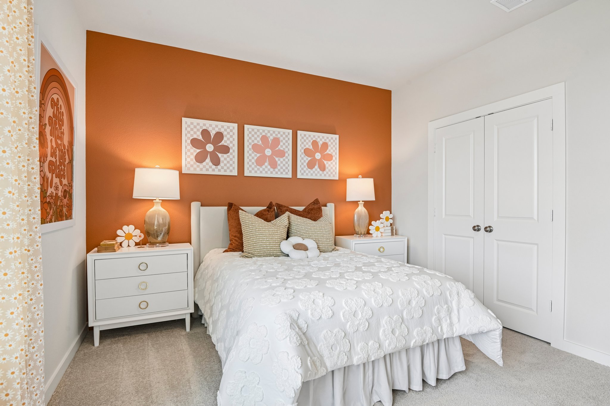 A bedroom with a bed and lamps.