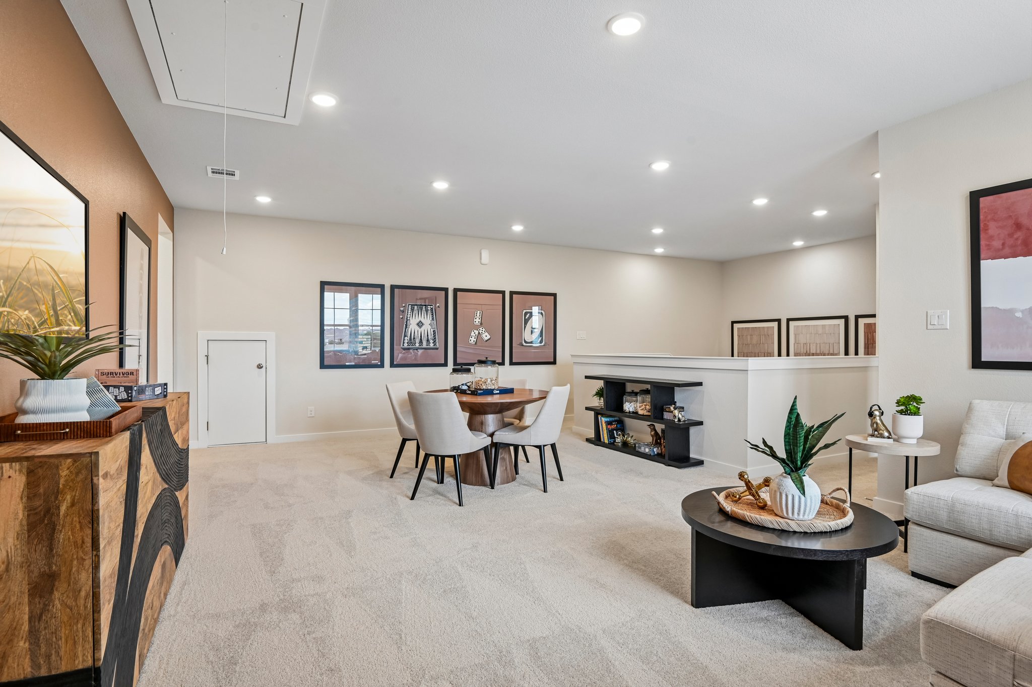 A large living room with a dining table and chairs.