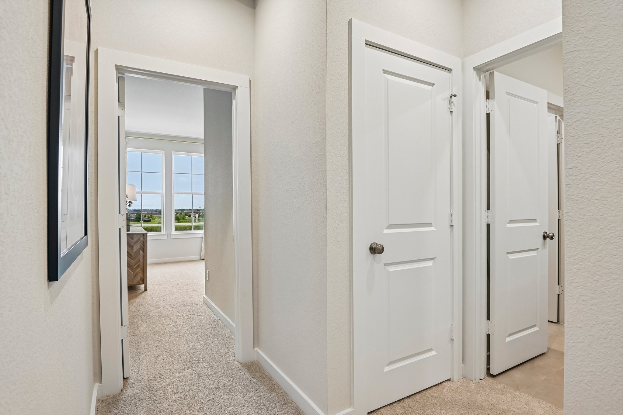 A hallway with white doors.