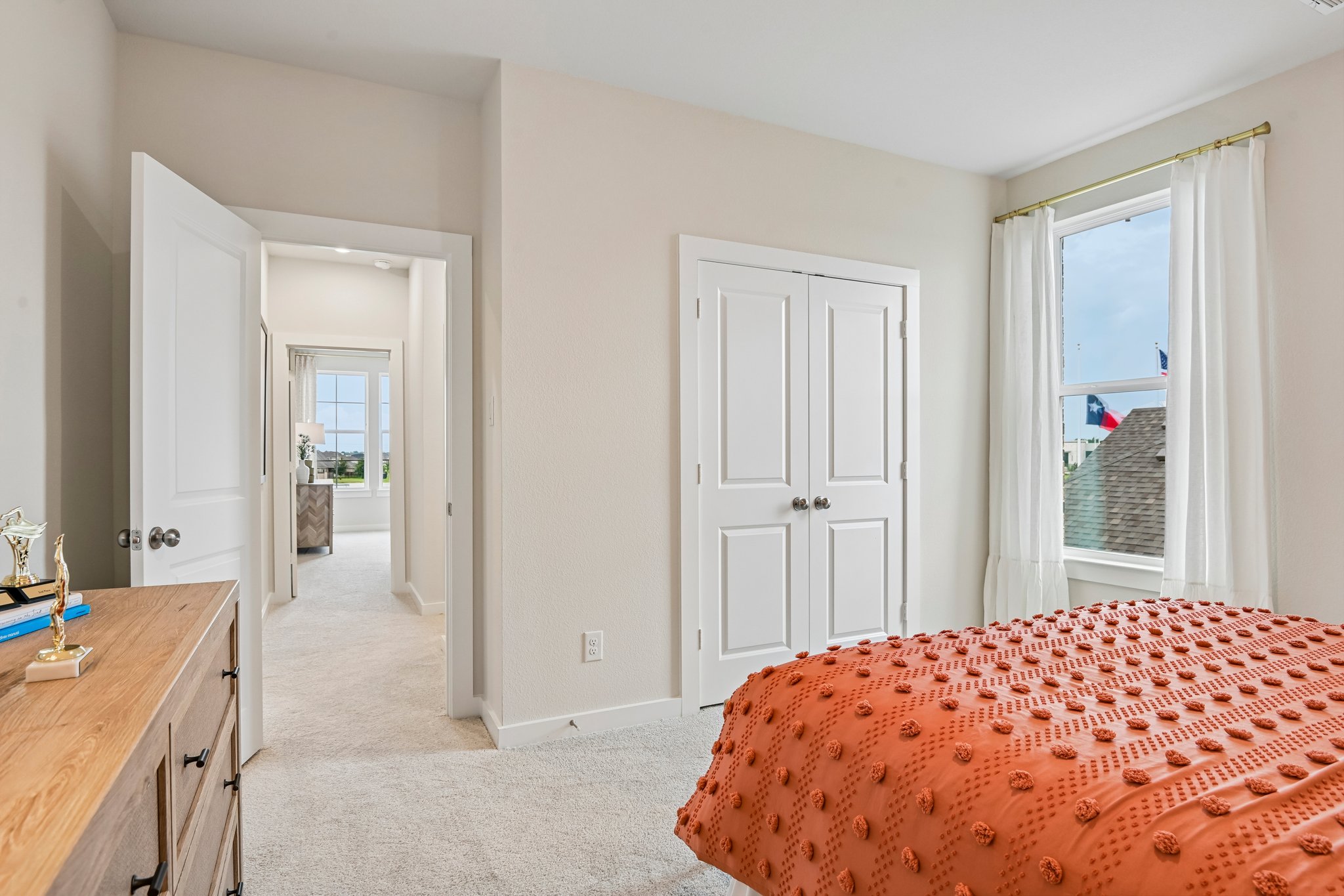 A bedroom with a bed and a window.