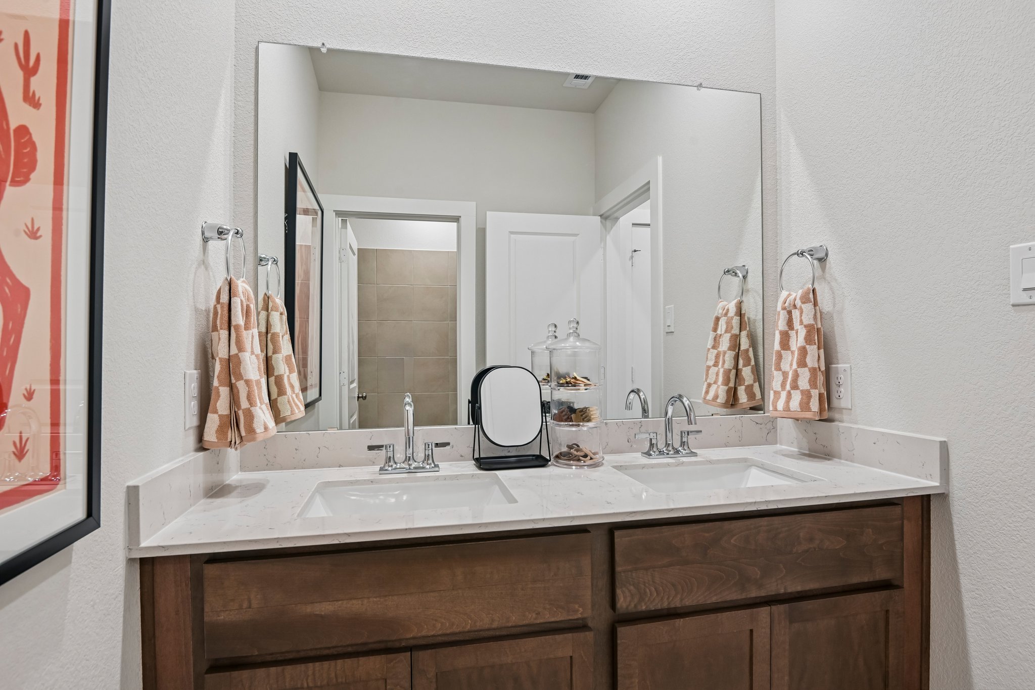 A bathroom with a large mirror.