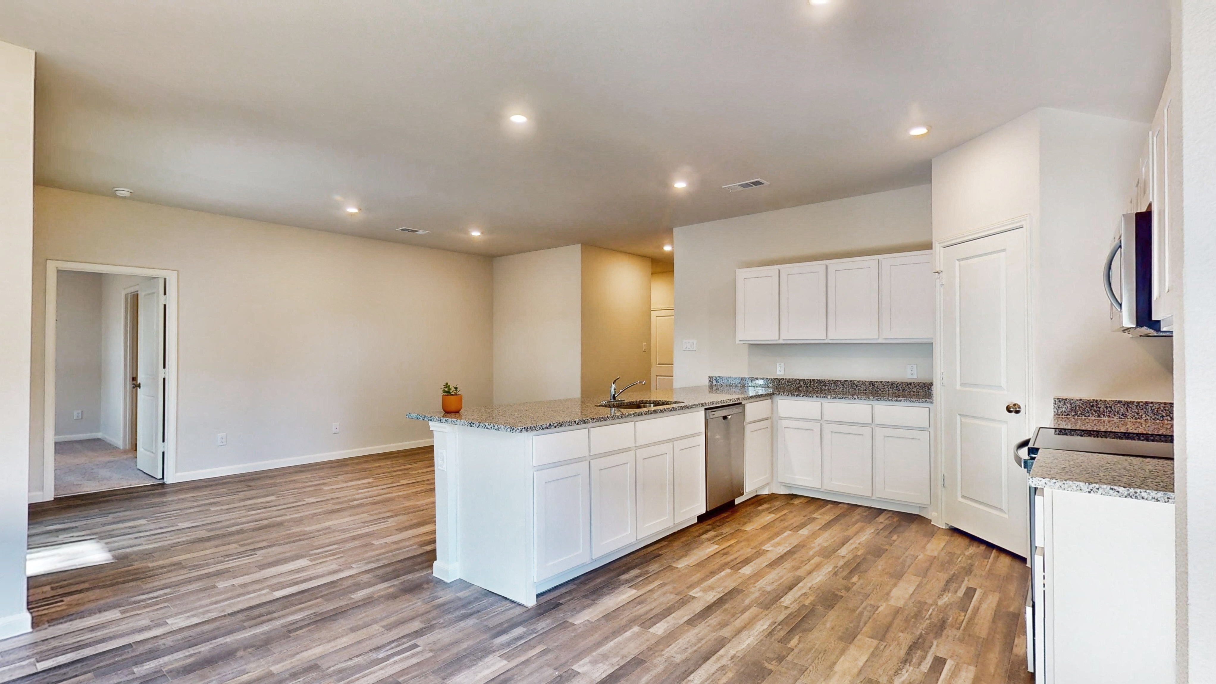 A kitchen with white cabinets.