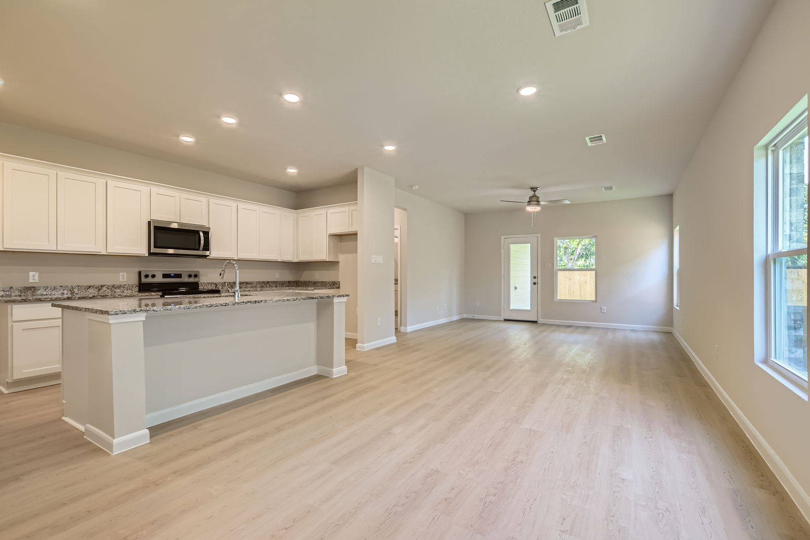 A large kitchen with white cabinets.