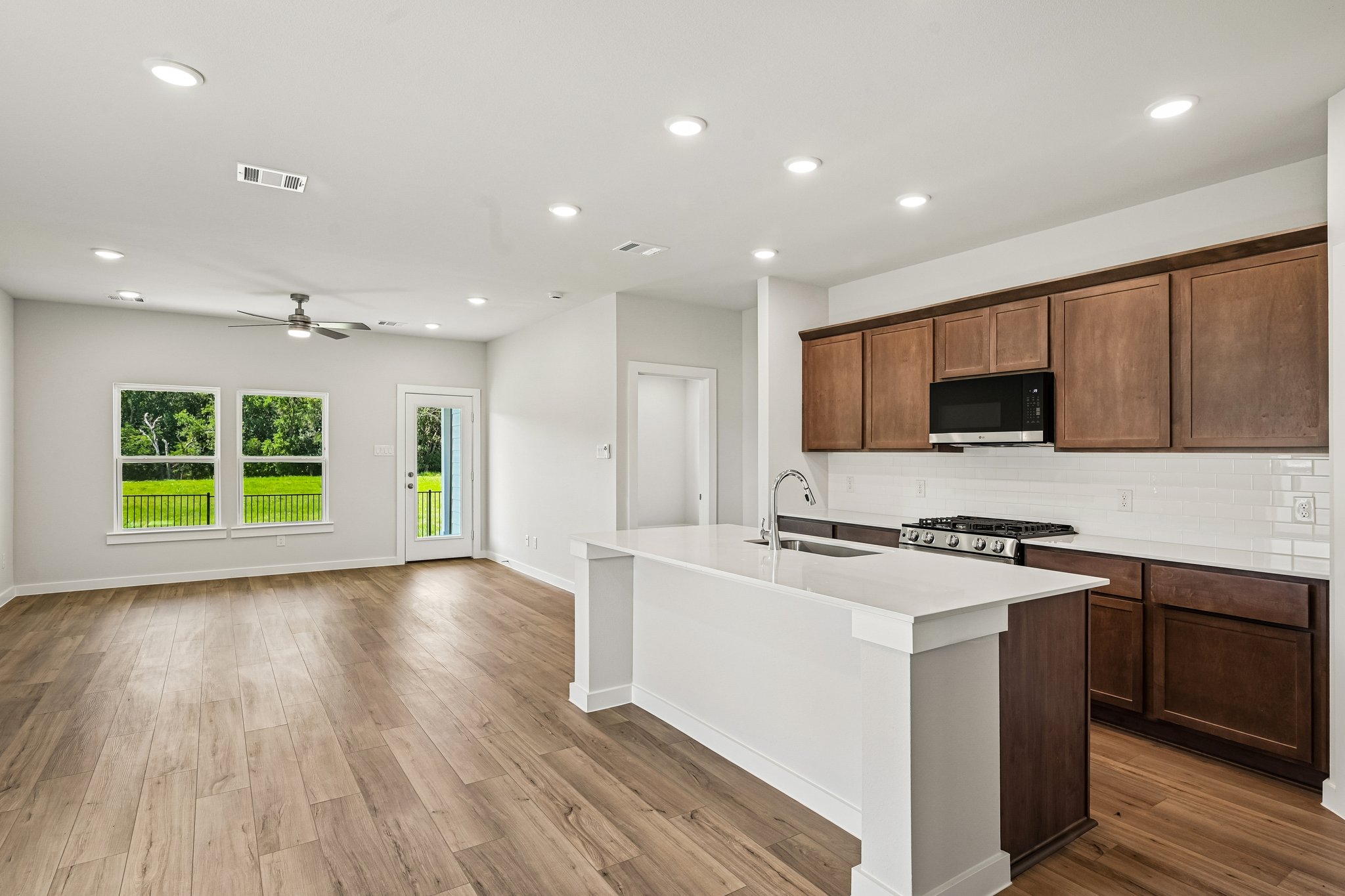 A kitchen with wooden cabinets.