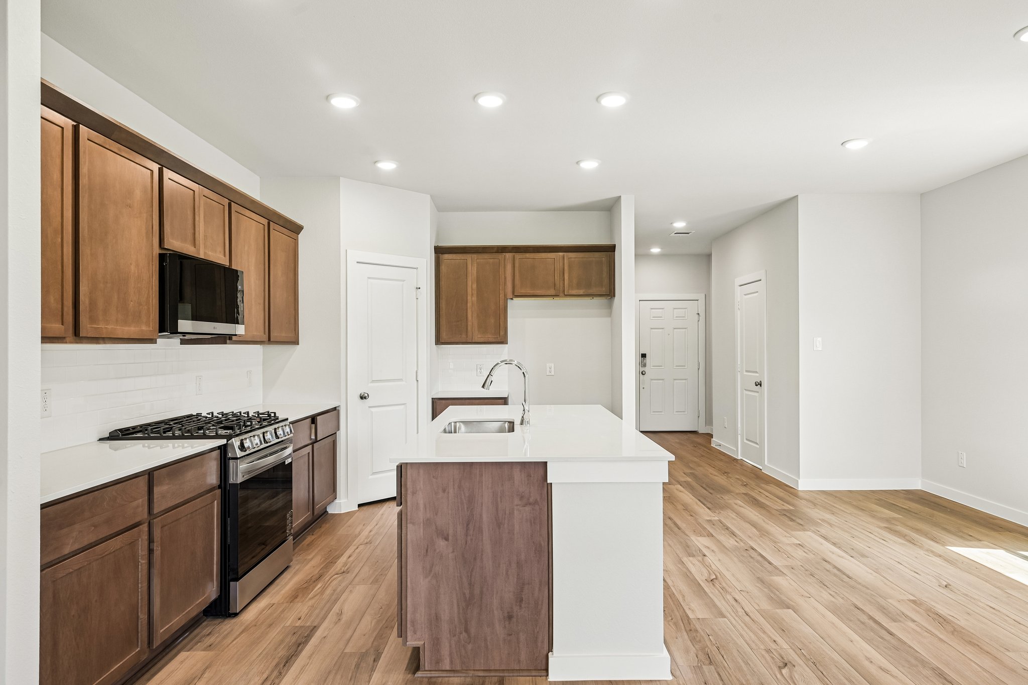 A kitchen with wooden cabinets.