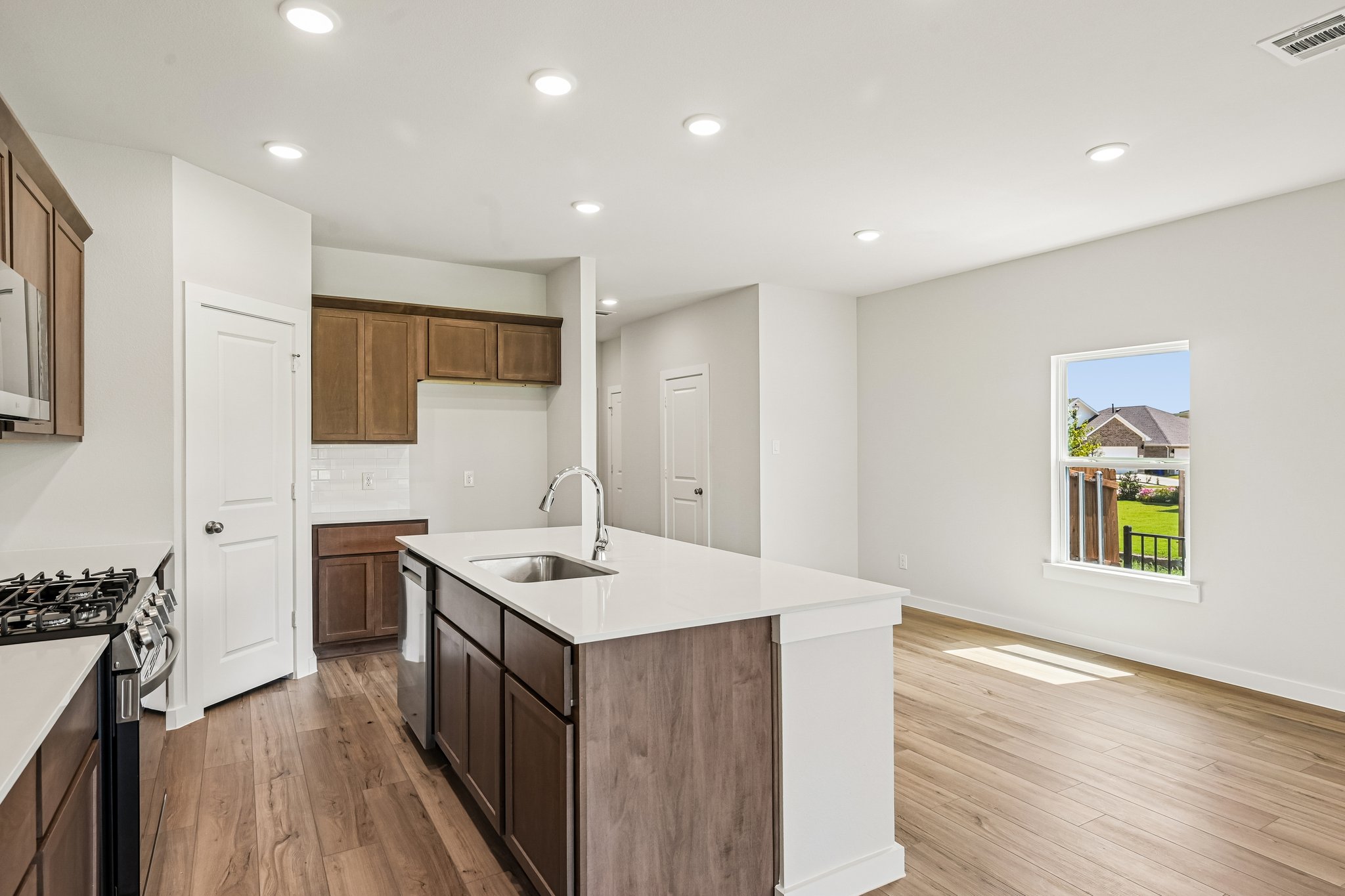 A kitchen with wooden cabinets.