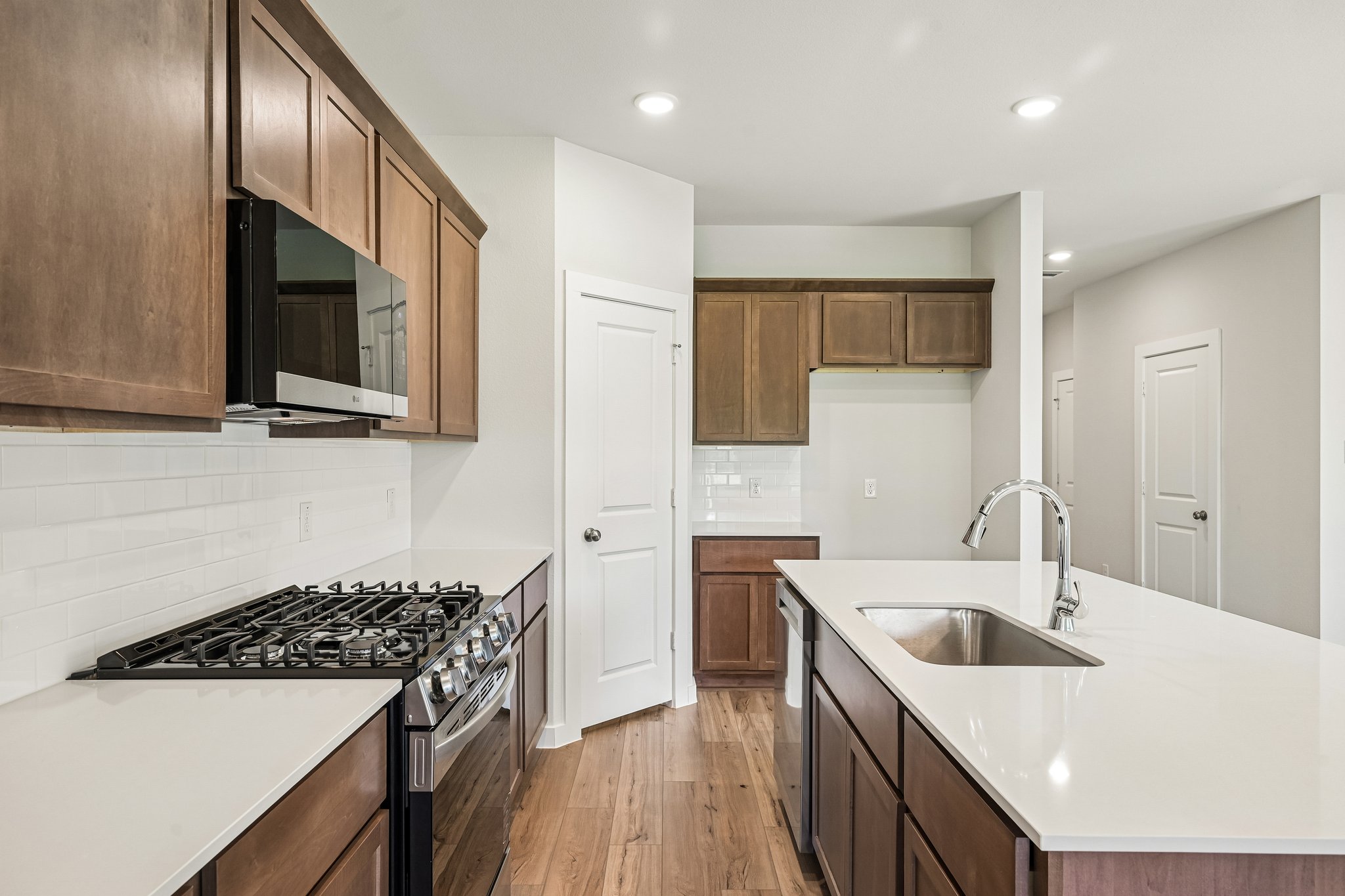 A kitchen with wooden cabinets.