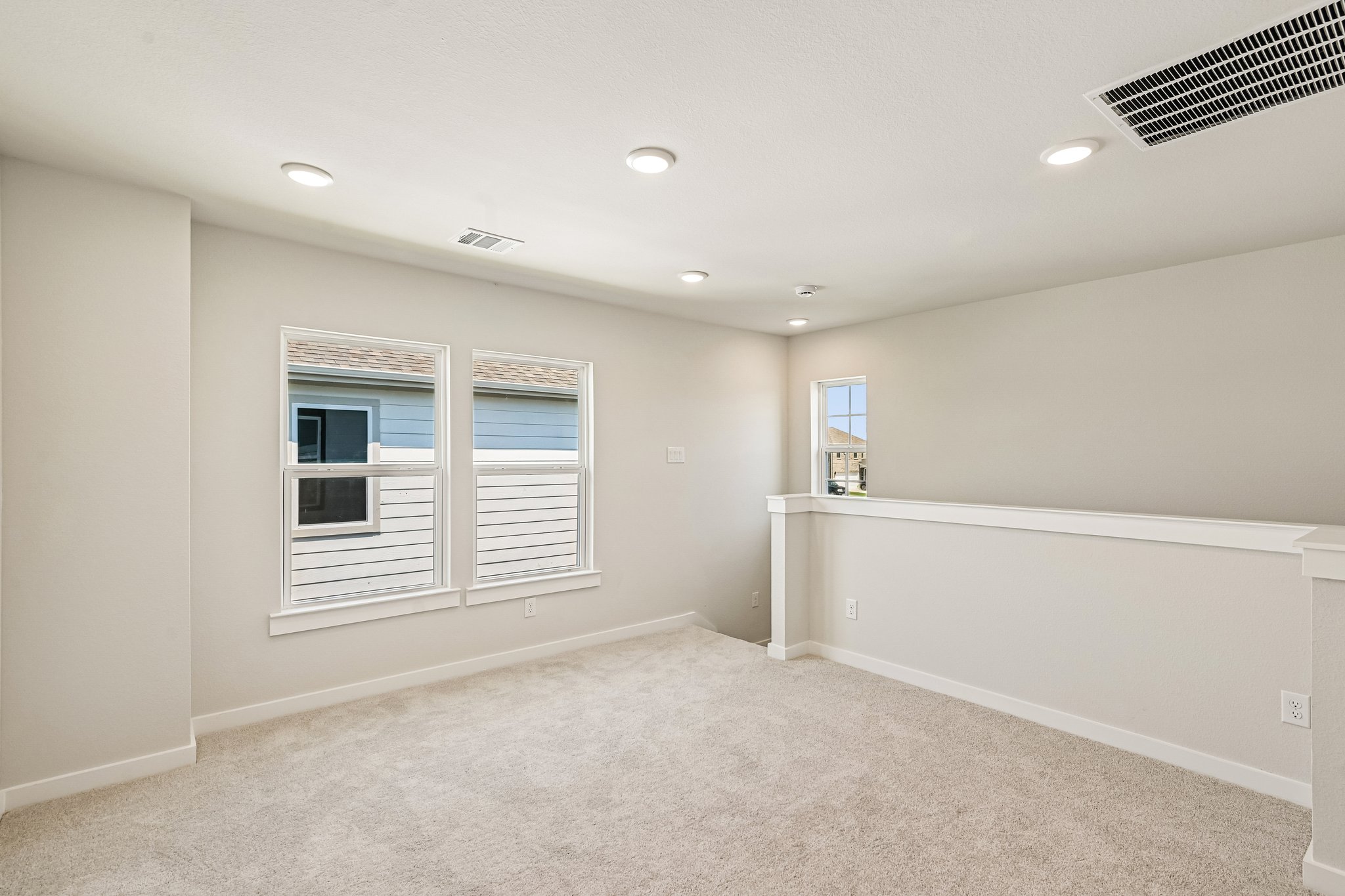 A room with a white wall and a window.