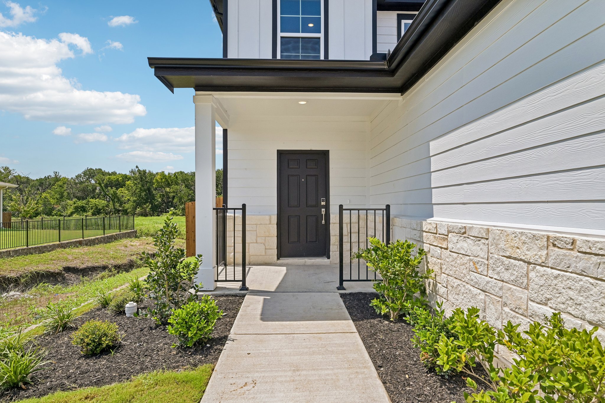 A building with a gate and grass.