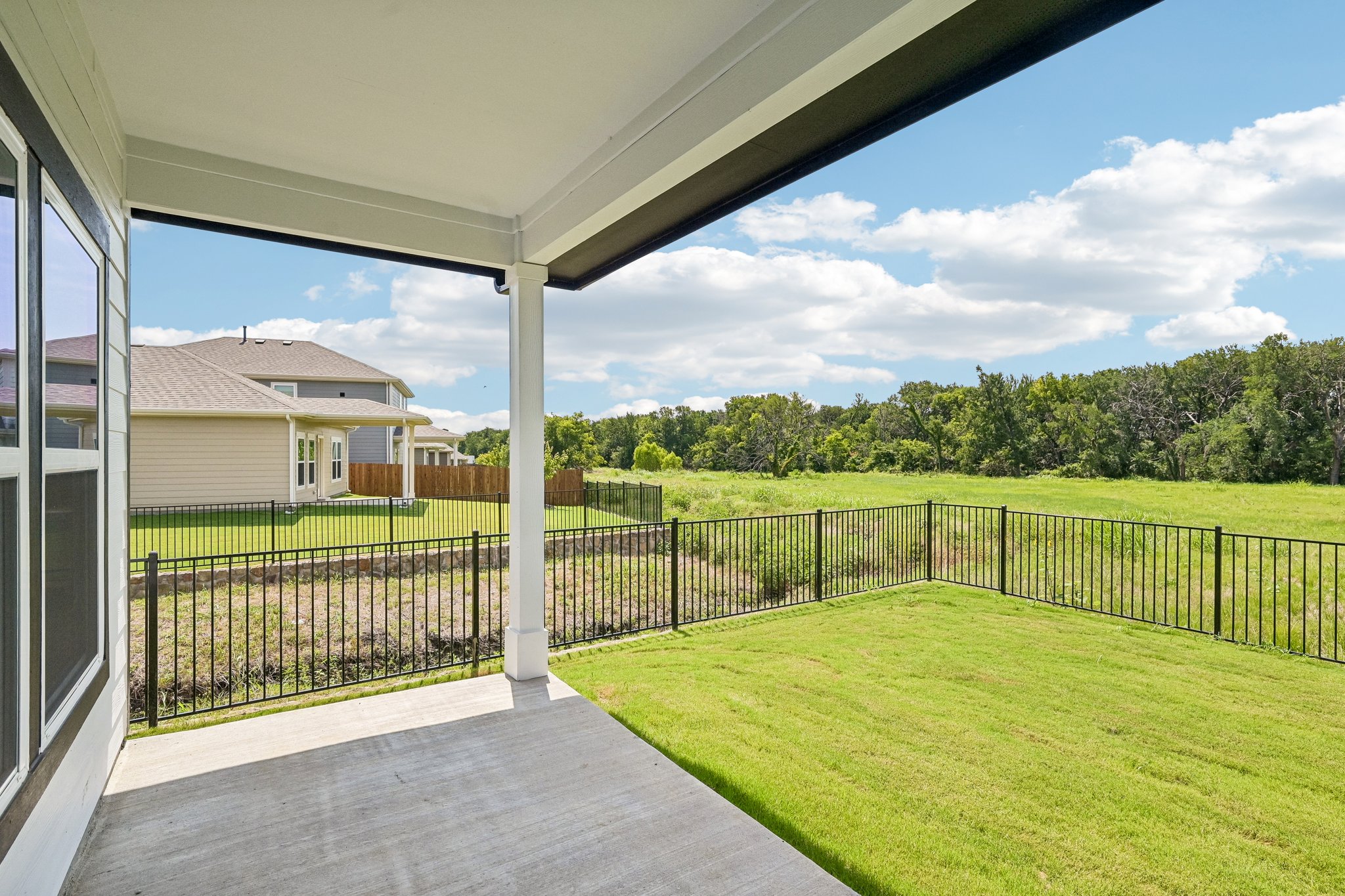 A house with a fence and grass.