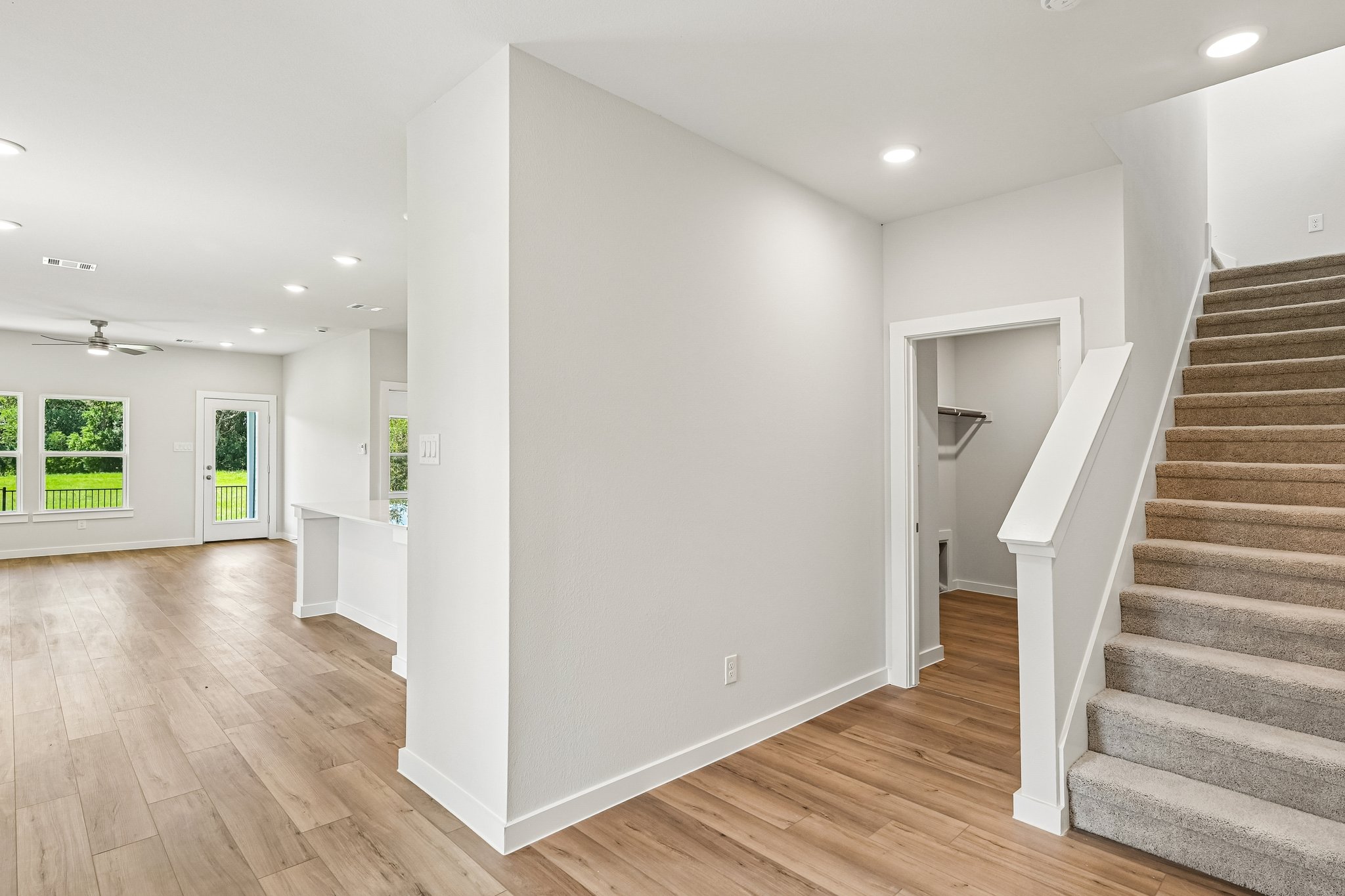 A room with white walls and wood floors.