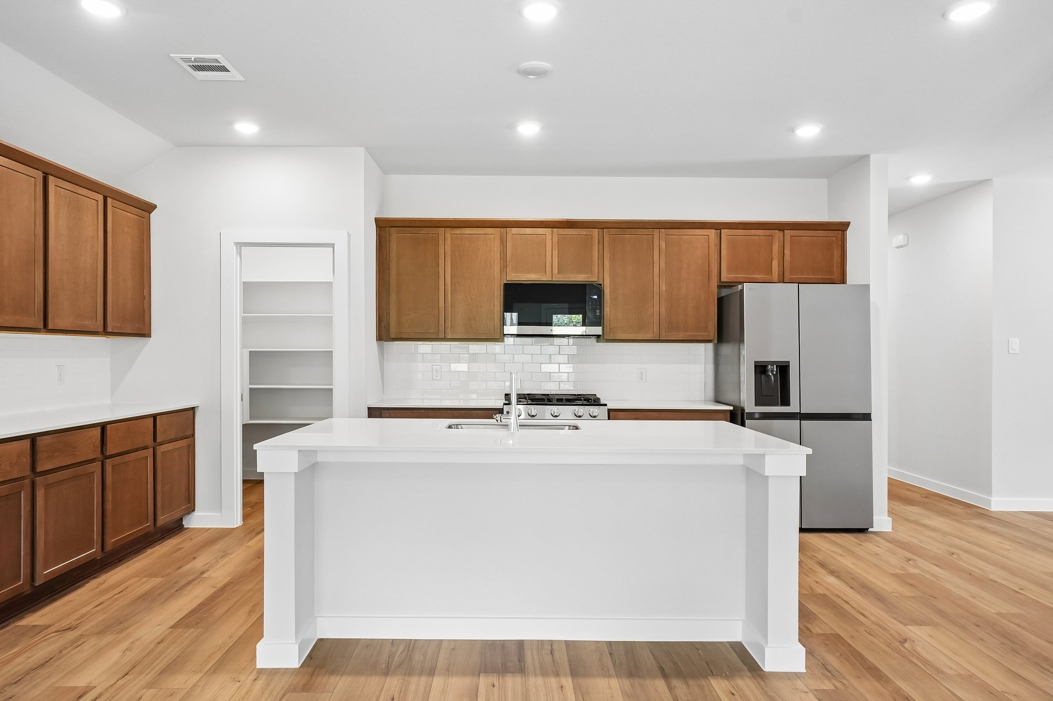 A kitchen with wooden cabinets.