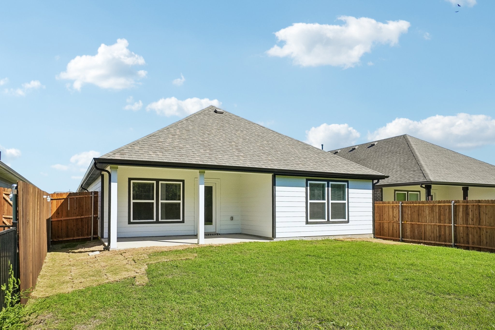 A house with a fence and grass.