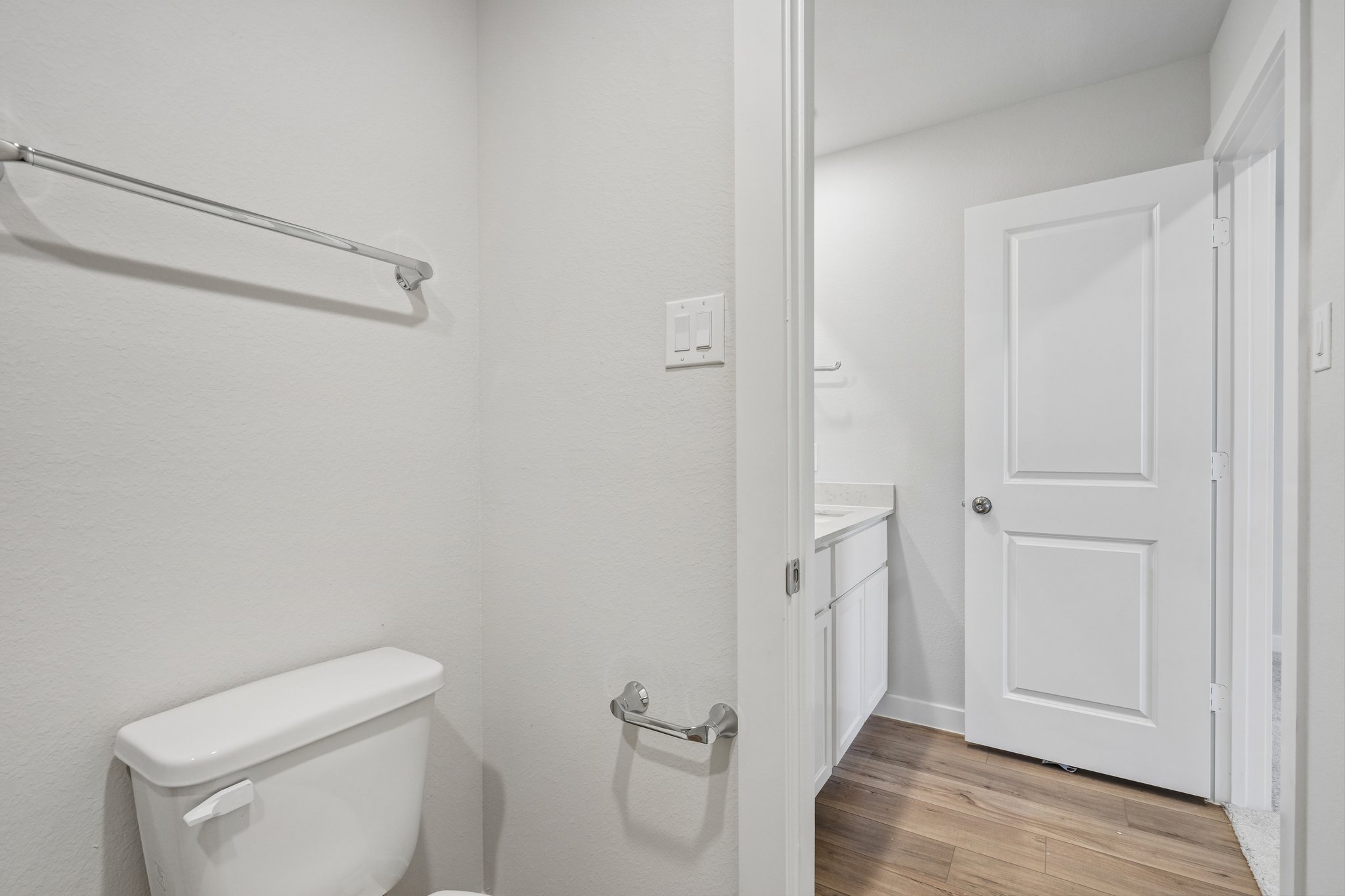 A bathroom with a toilet and a shower unit.