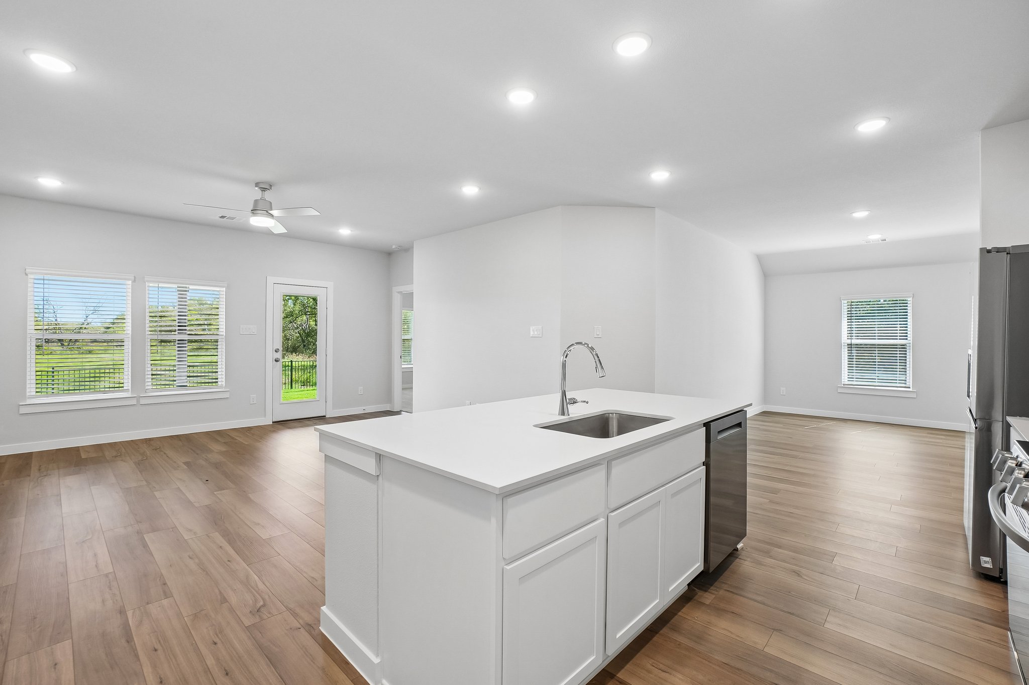 A kitchen with white cabinets.