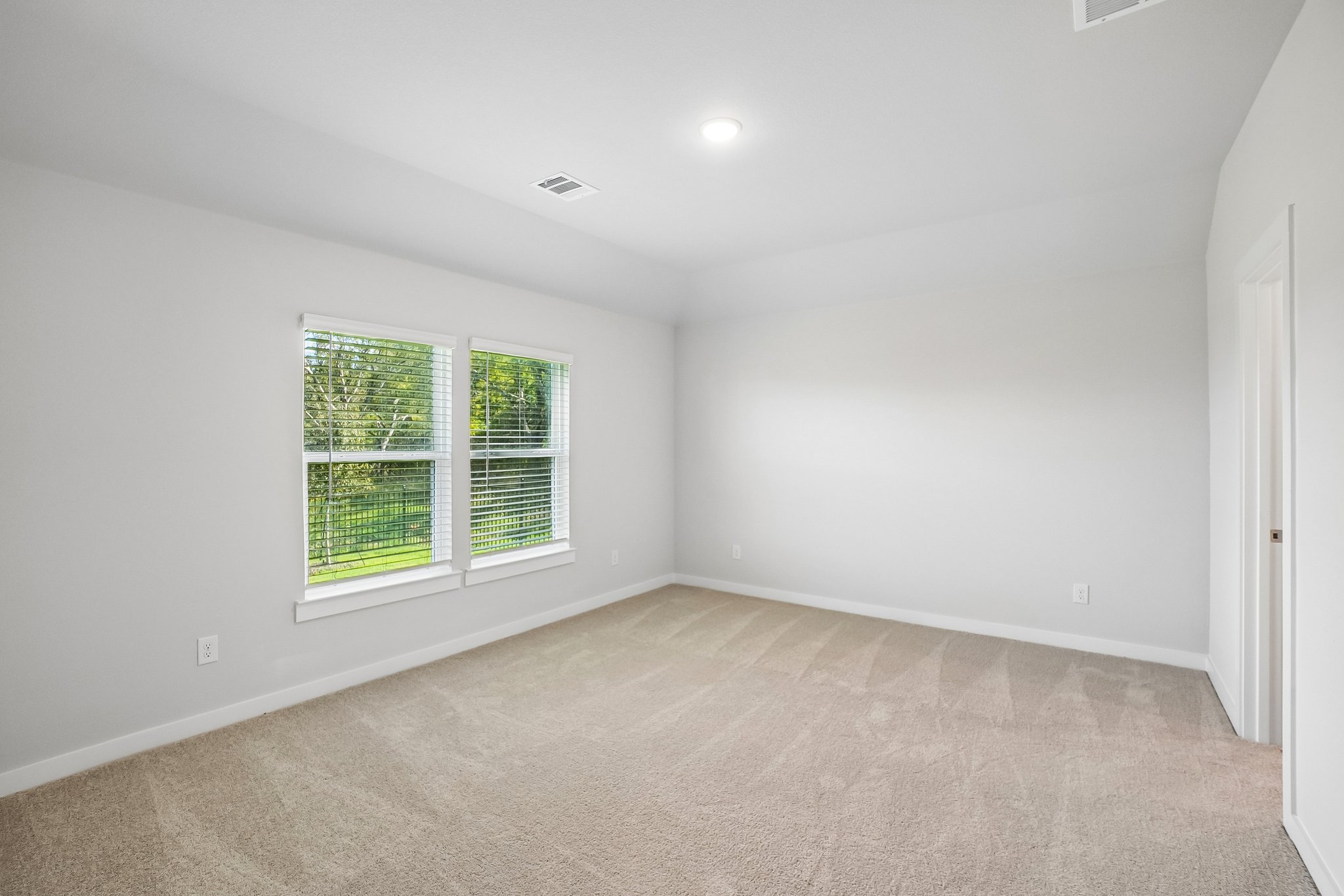 A room with a window and a door.