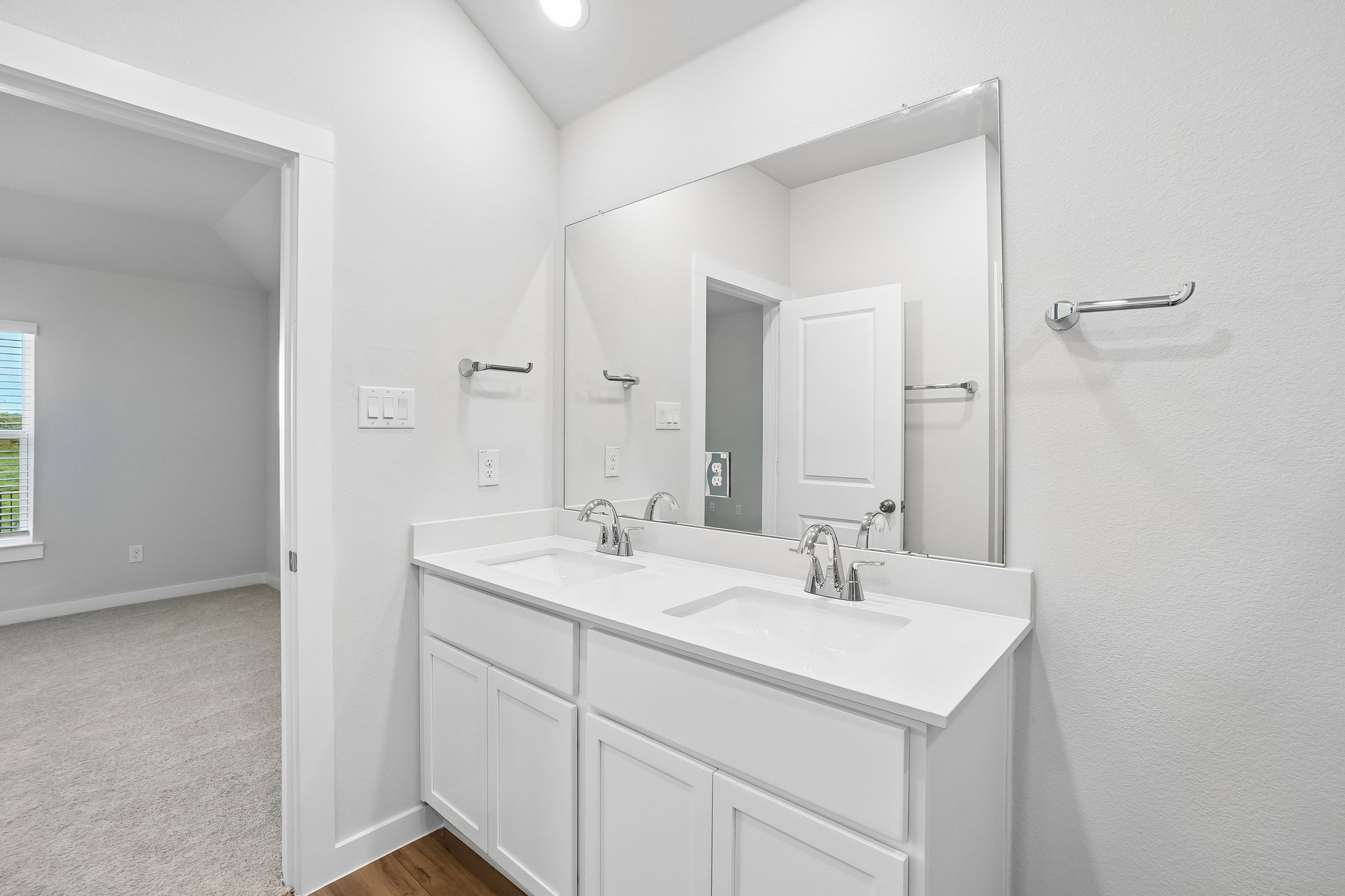 A bathroom with a large mirror.
