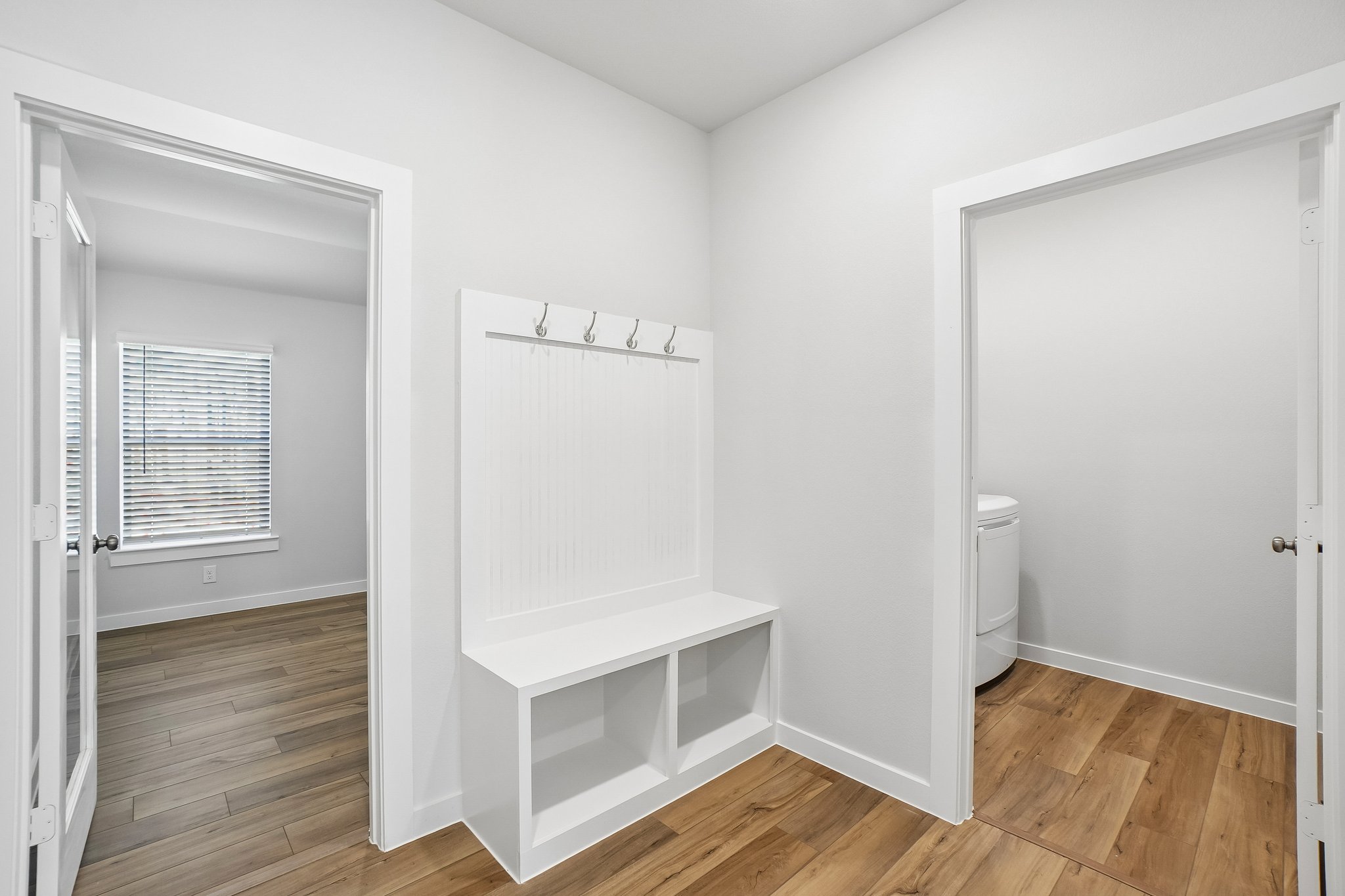 A white room with a white shelf.