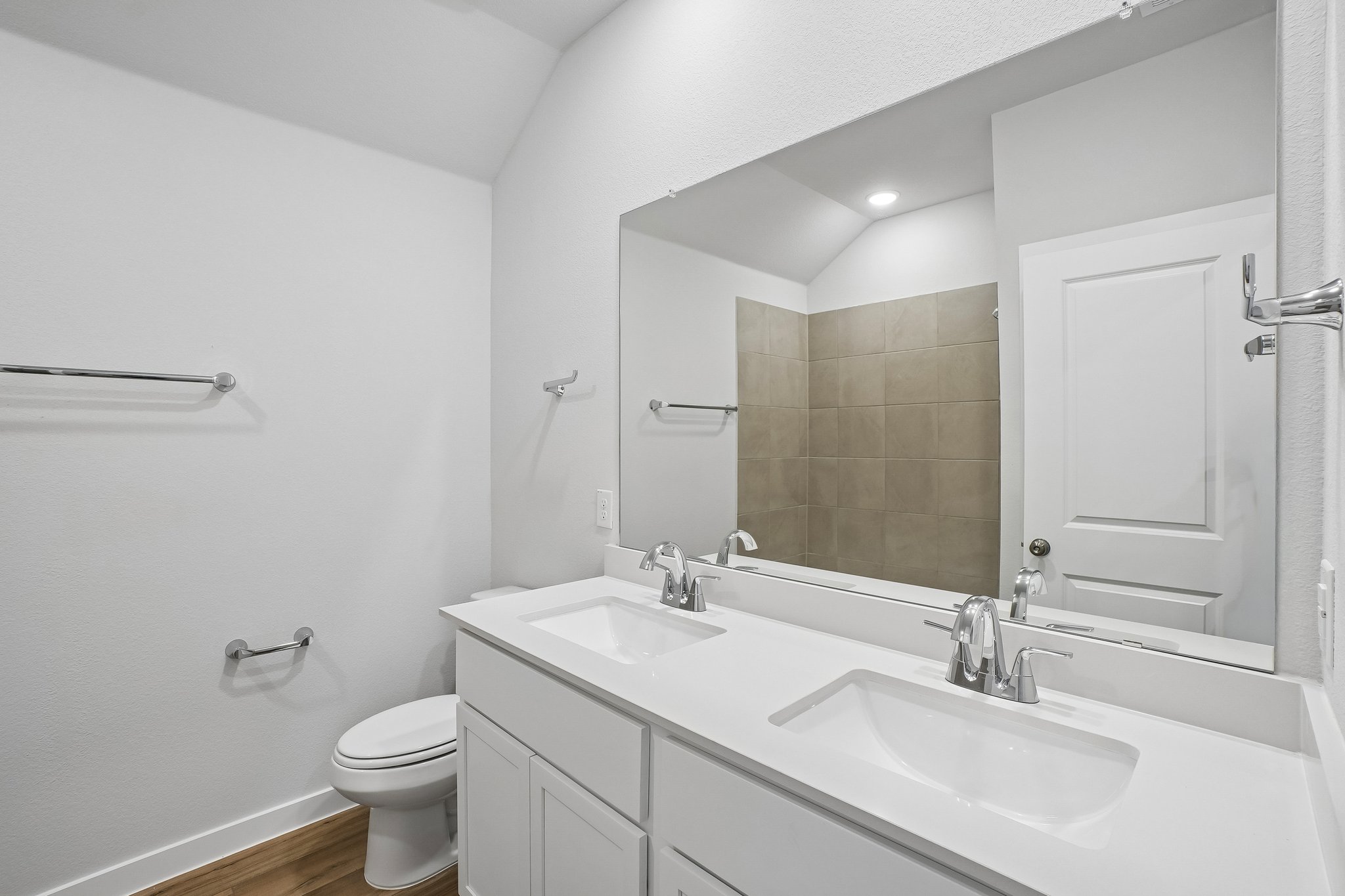 A bathroom with a large mirror.