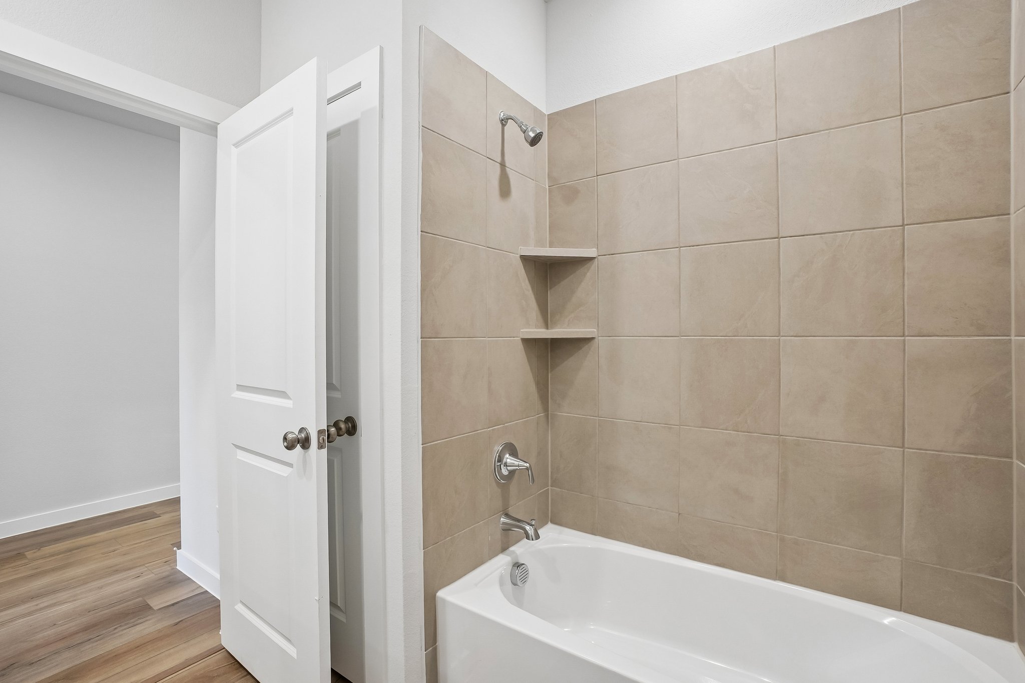 A bathroom with a bathtub and shower.
