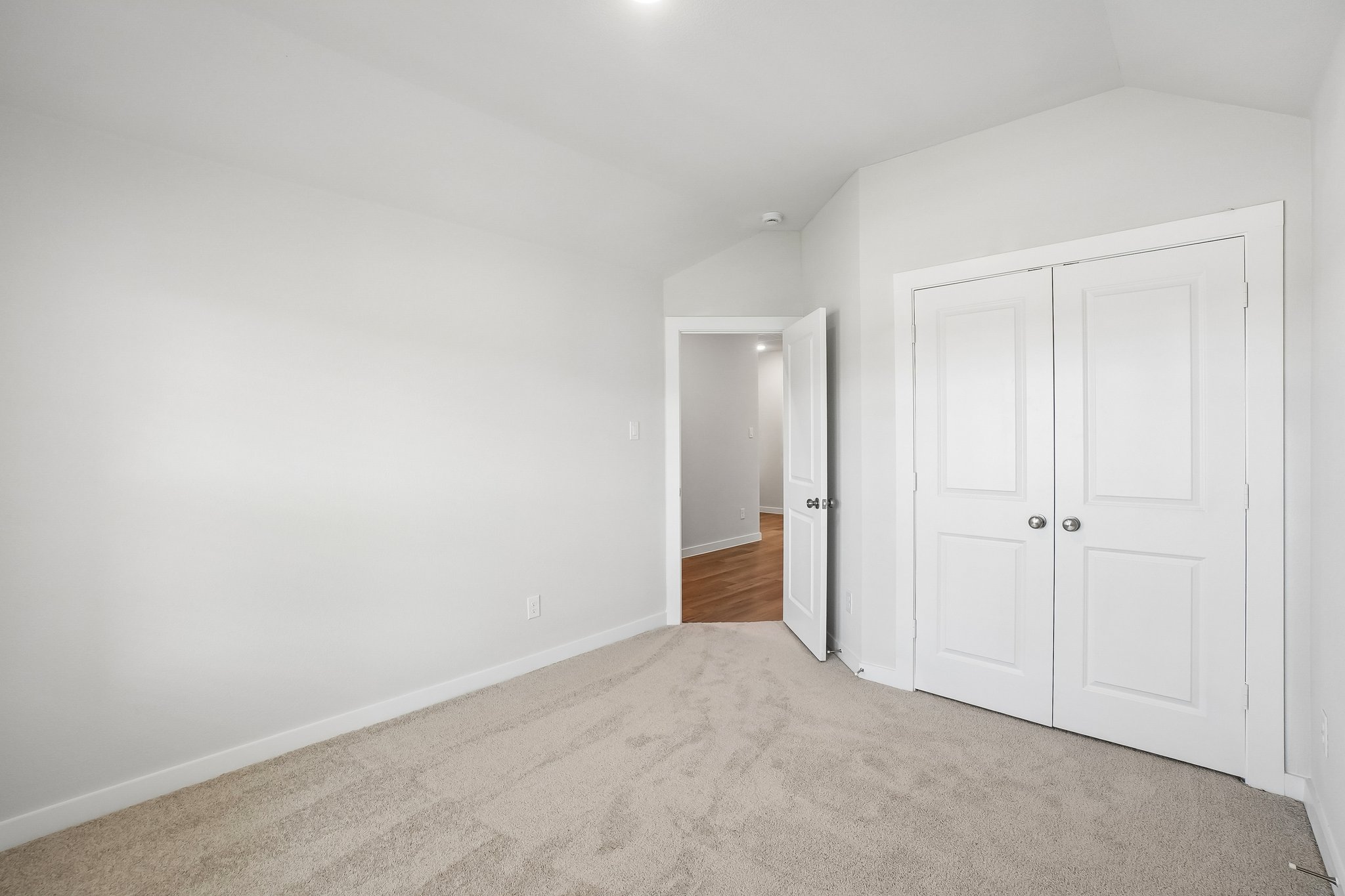A hallway with white doors.