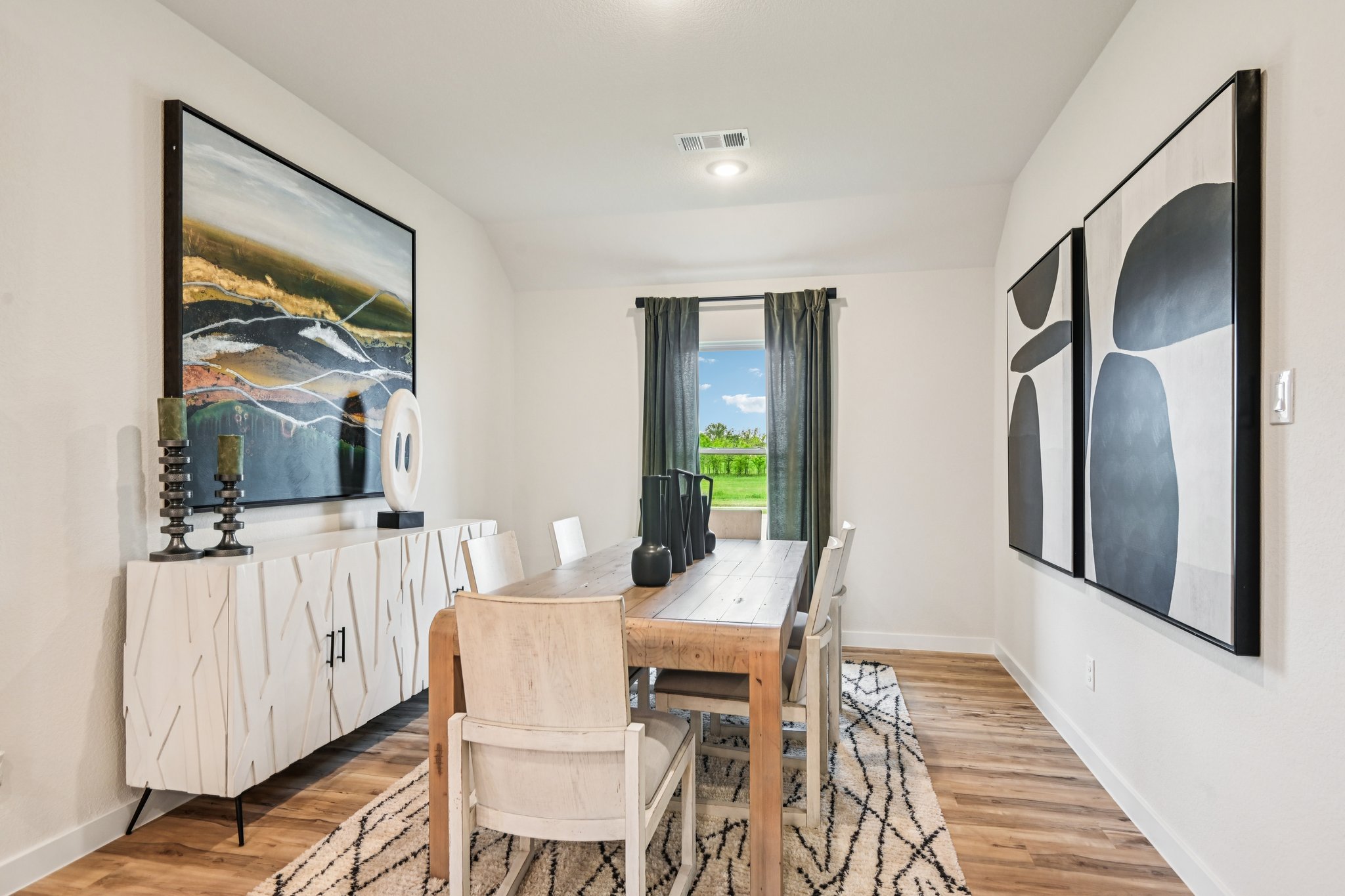 A dining room with a table and chairs.