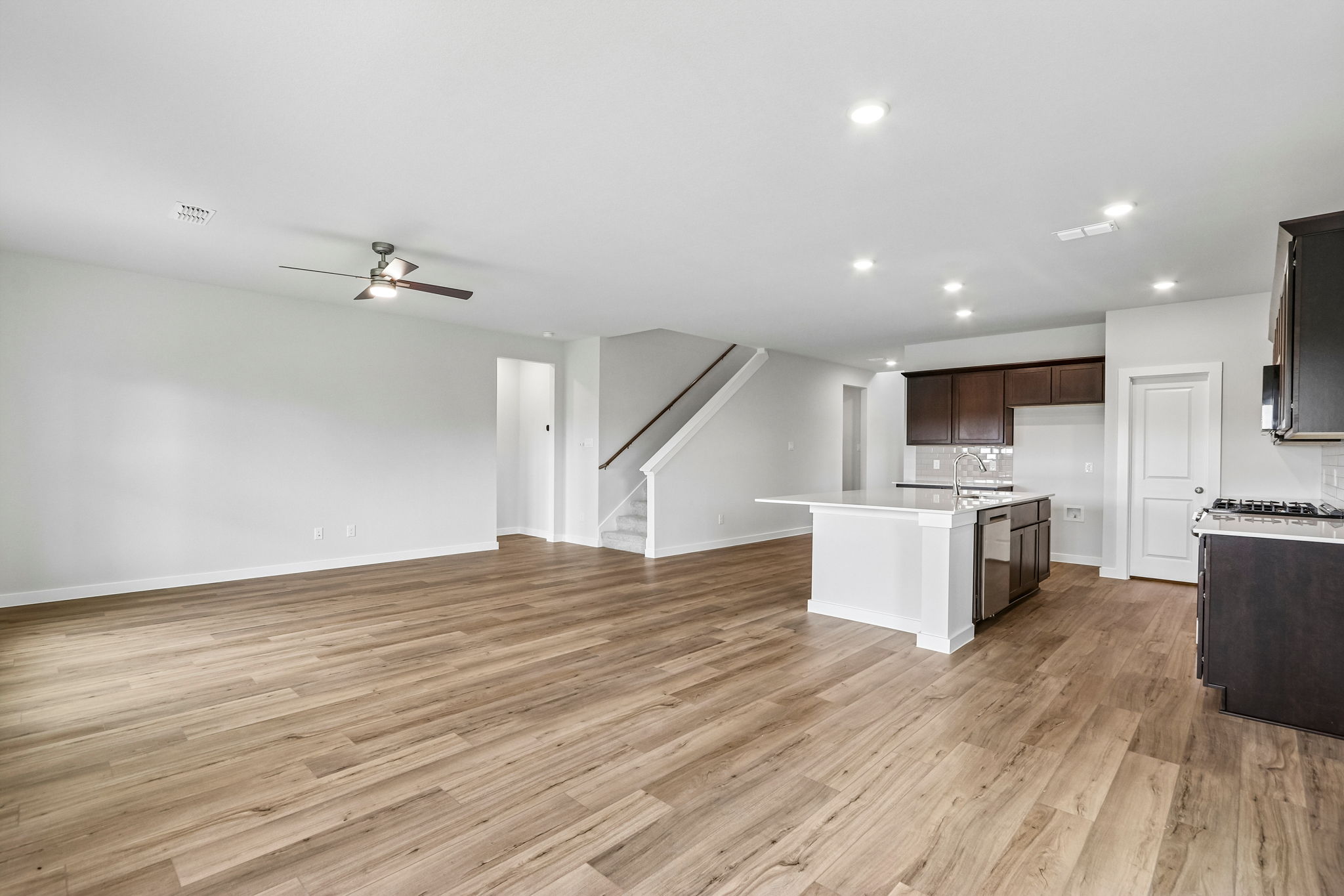 A large kitchen with wood floors.