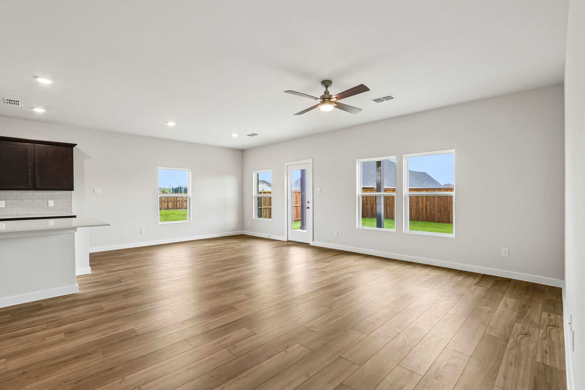 A large room with a wood floor and a wood floor.