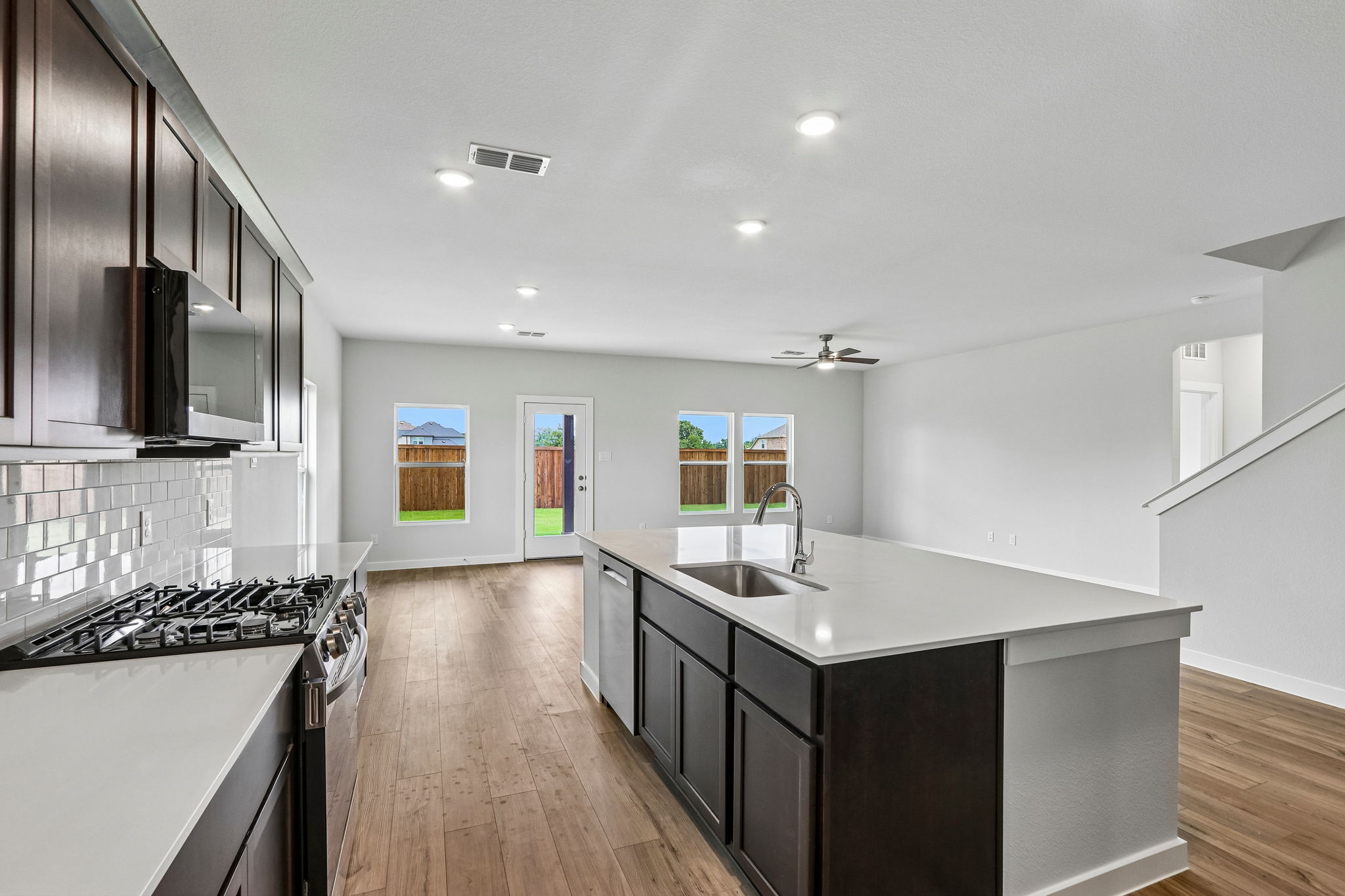 A kitchen with black cabinets.