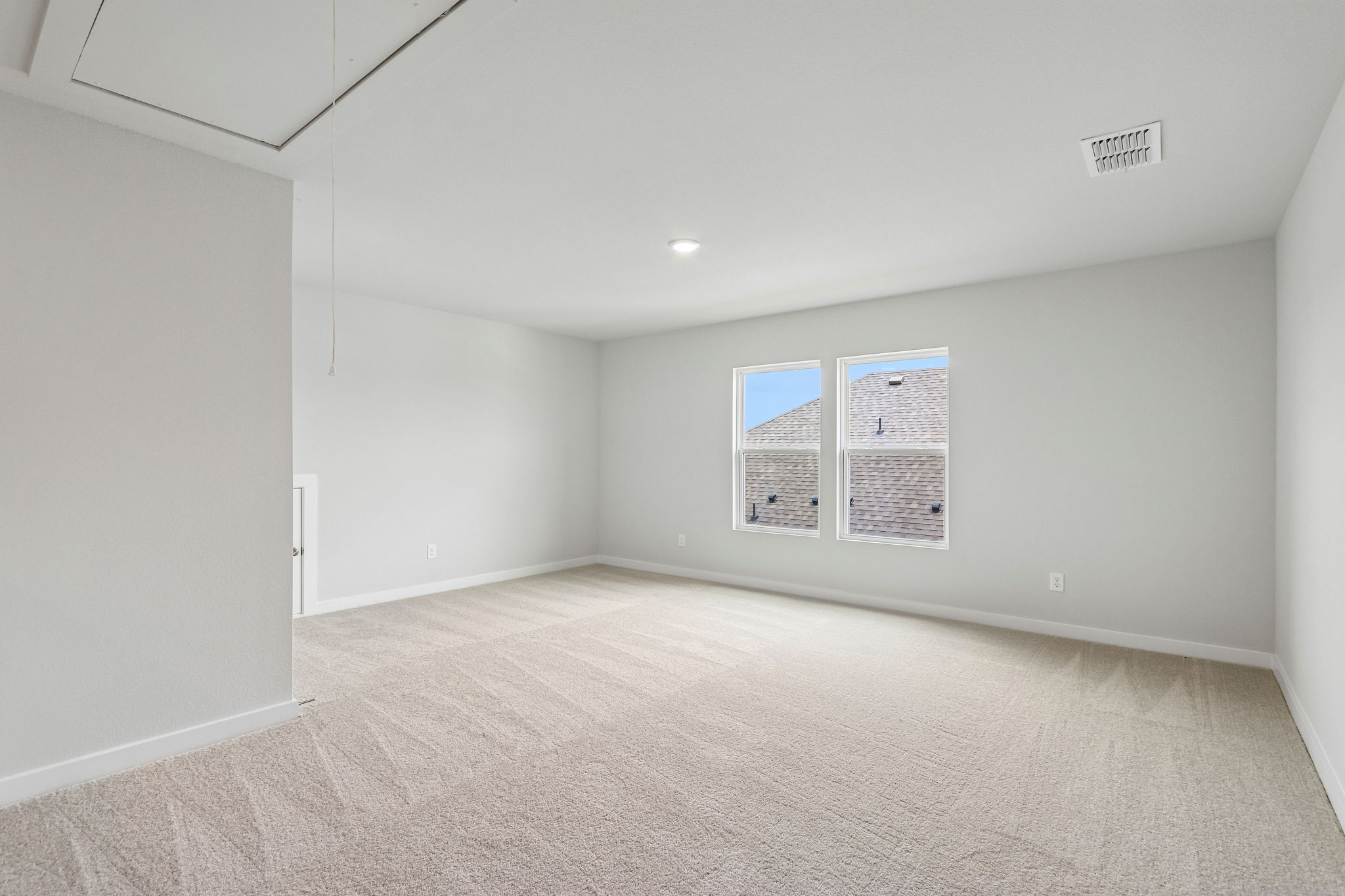 A room with a carpet and a poster on the wall.