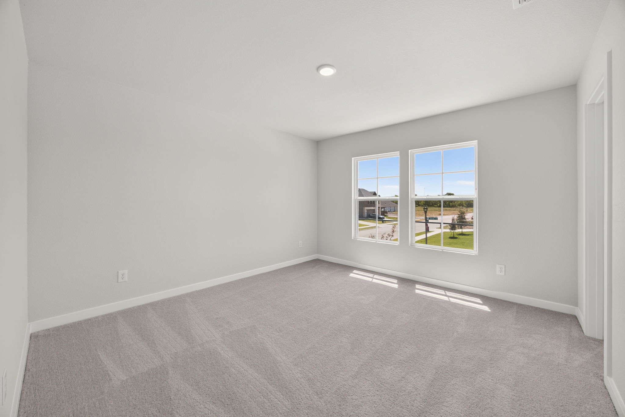 A room with a window and a carpet.