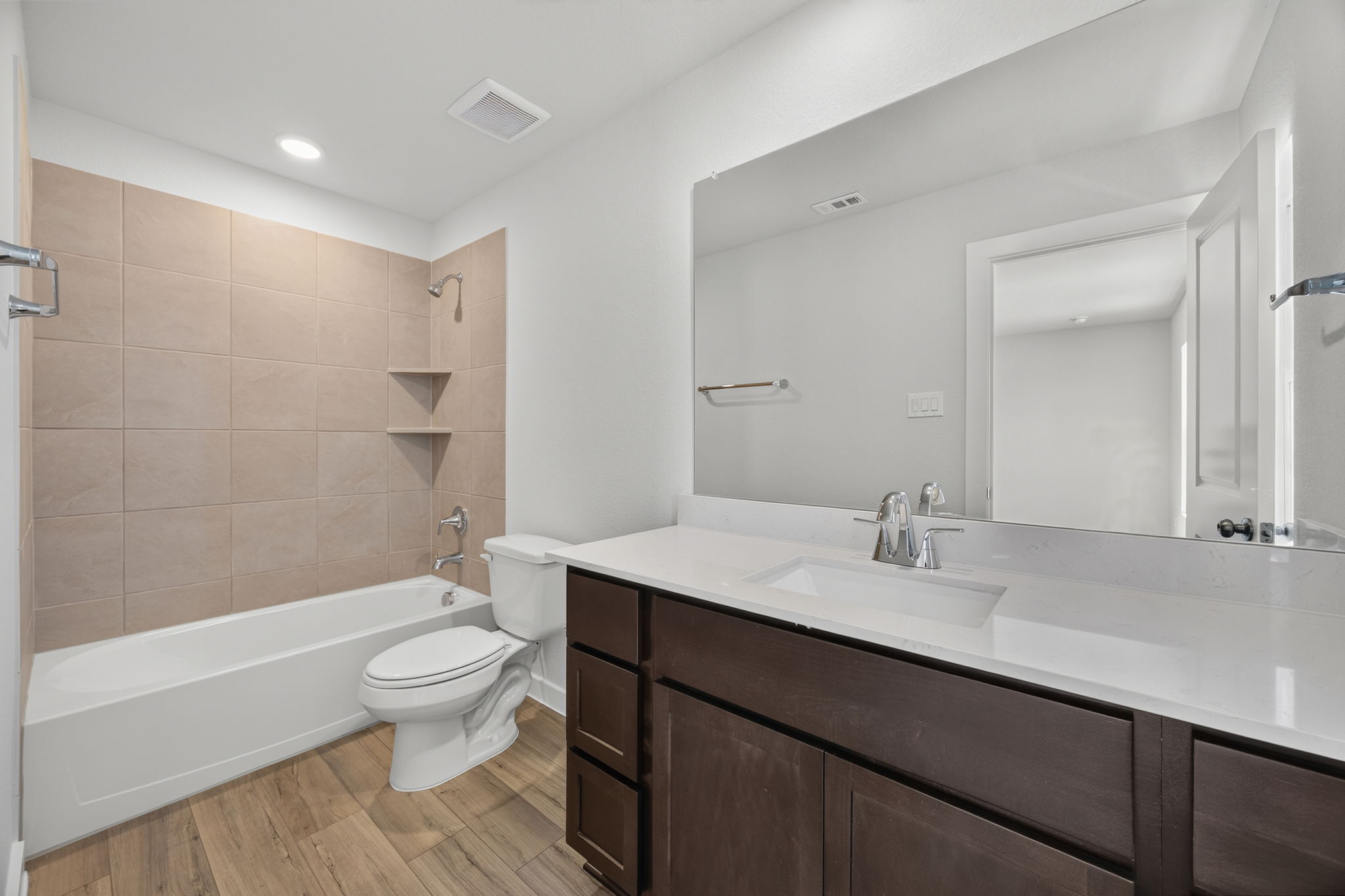 A bathroom with a tub sink and toilet.