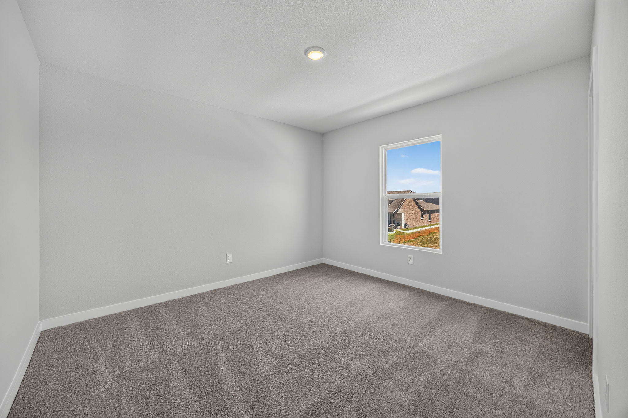 A room with a carpet and a painting on the wall.