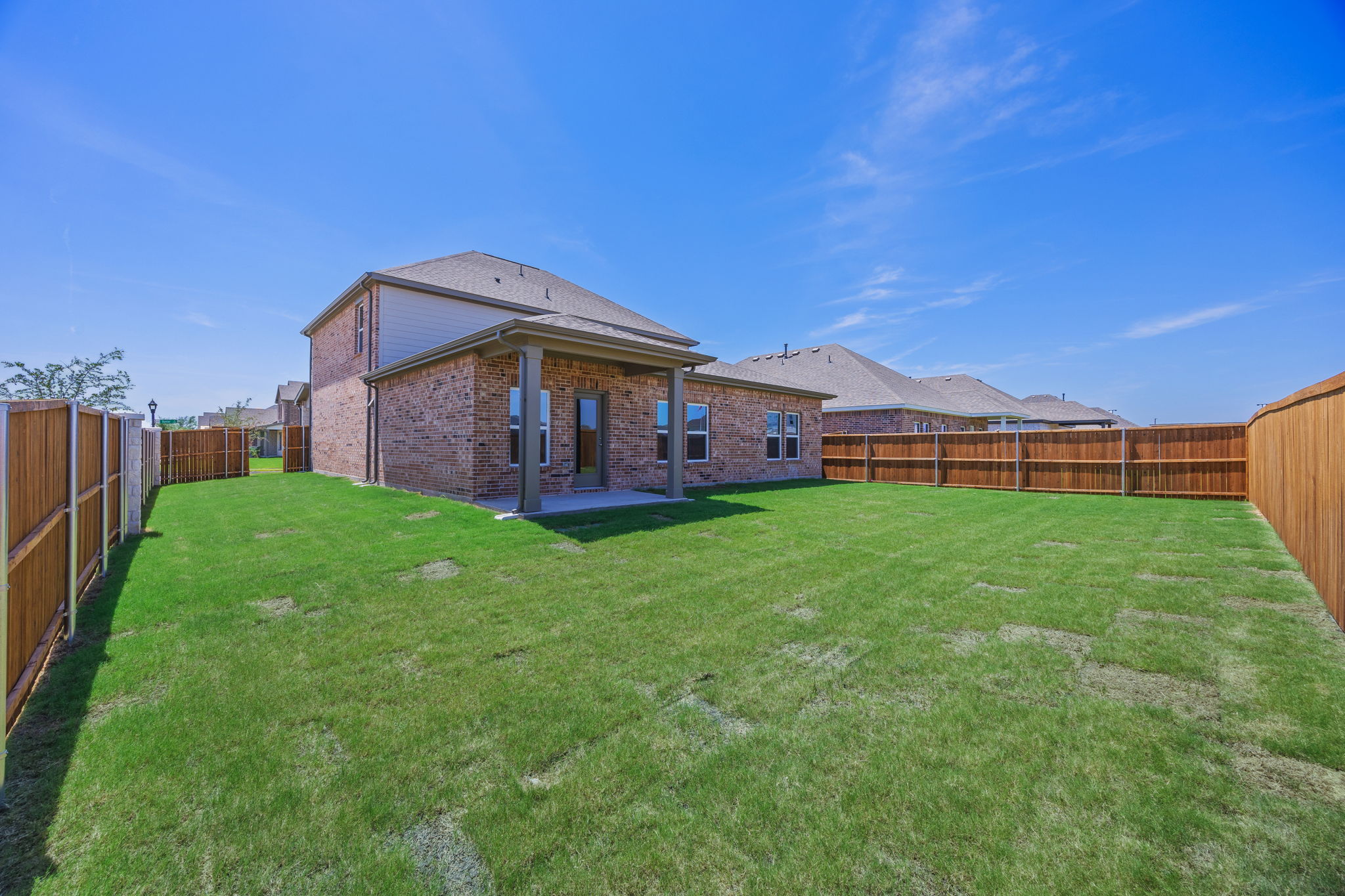 A house with a fence and grass.