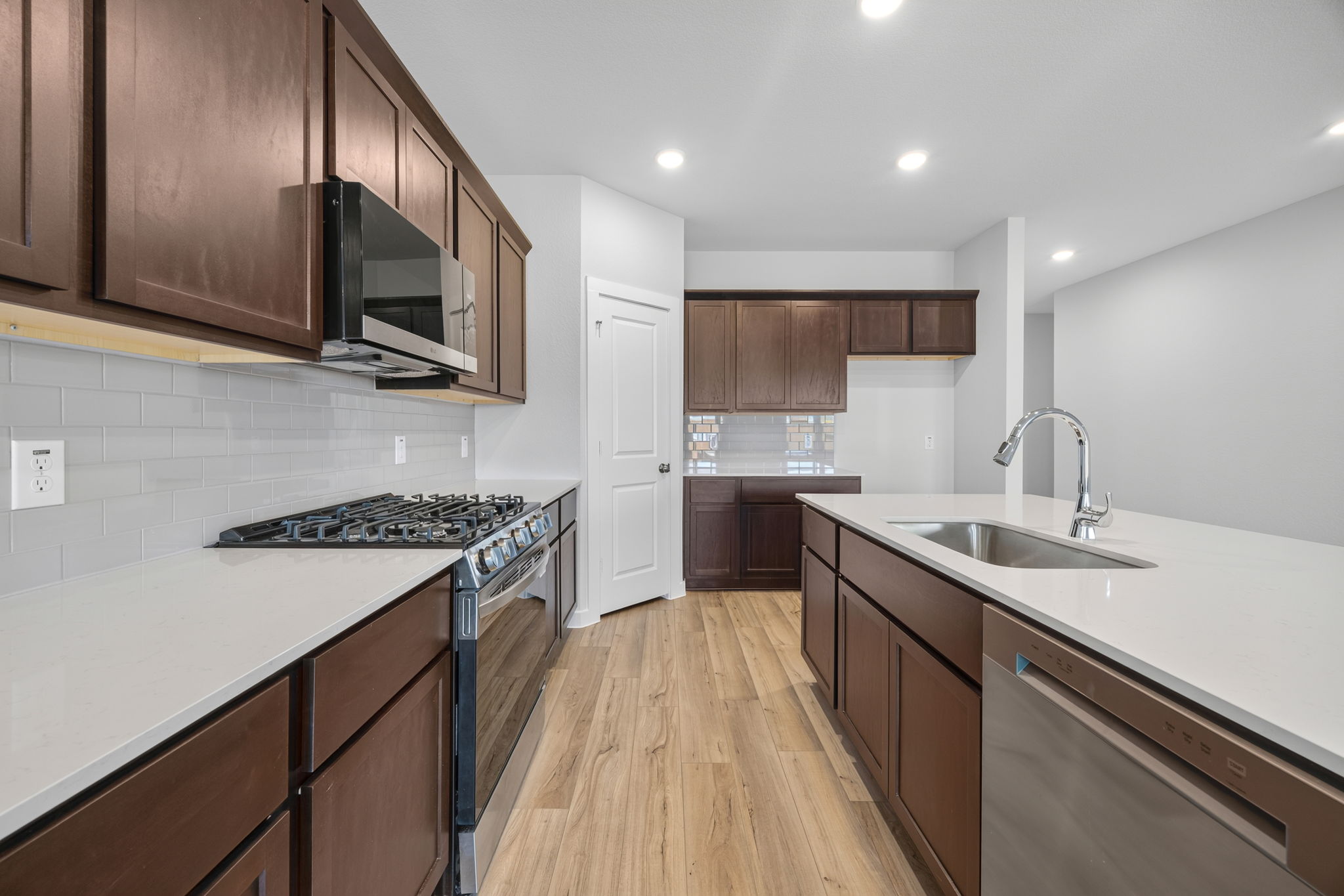 A kitchen with wooden cabinets.