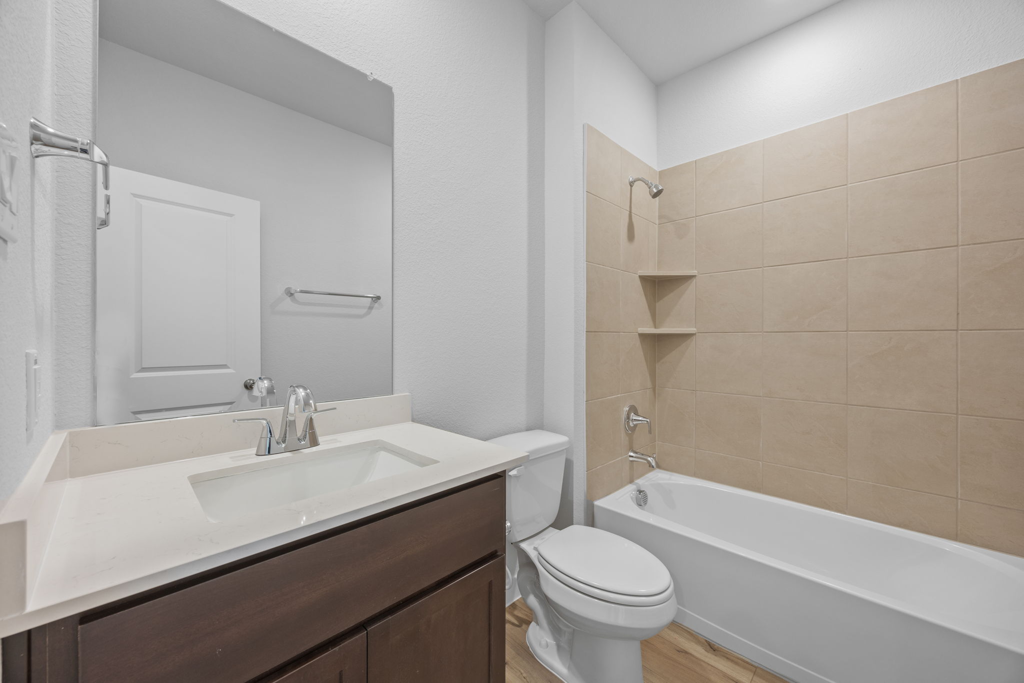 A bathroom with a tub sink and toilet.