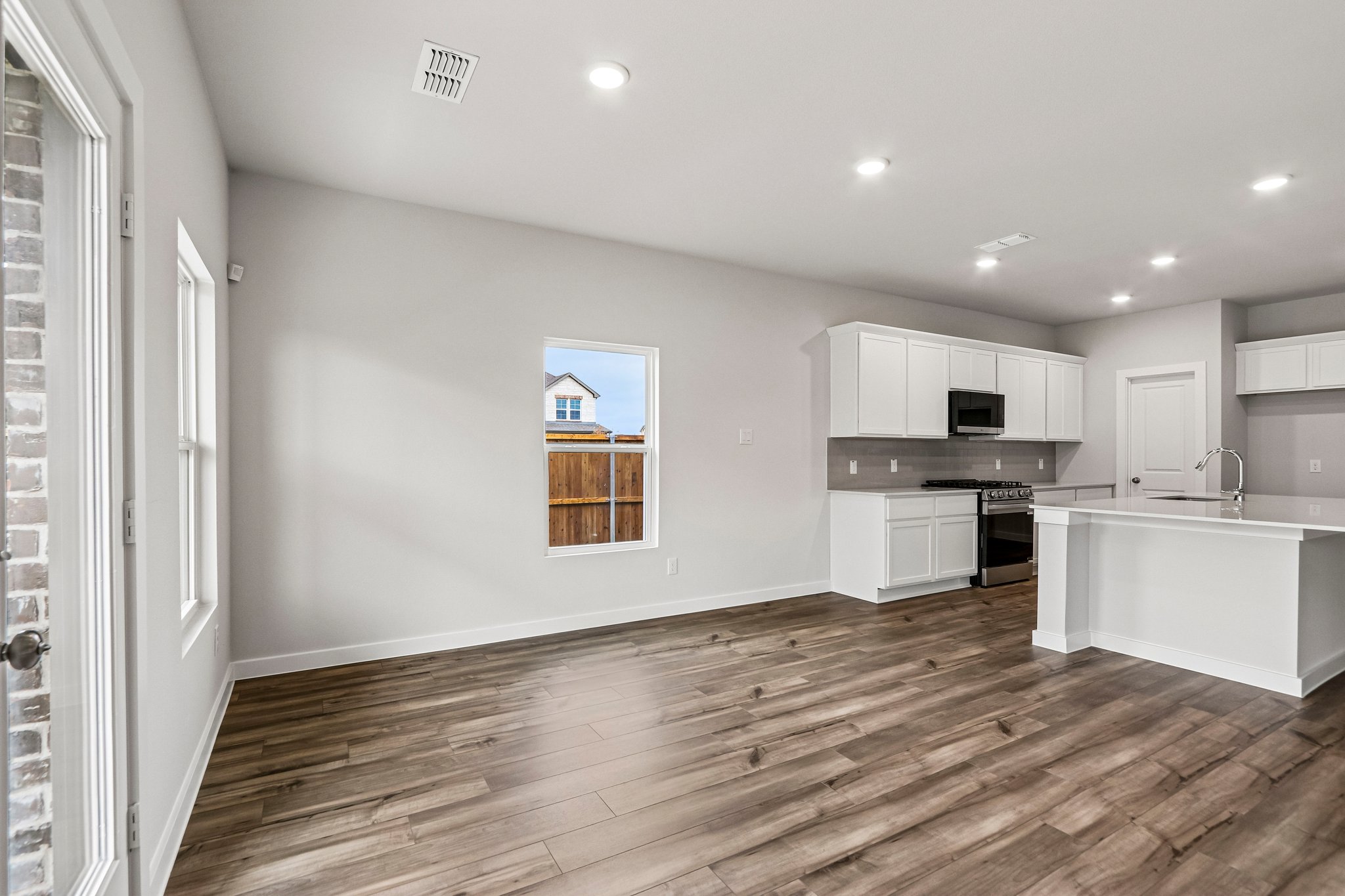 A kitchen with white cabinets.