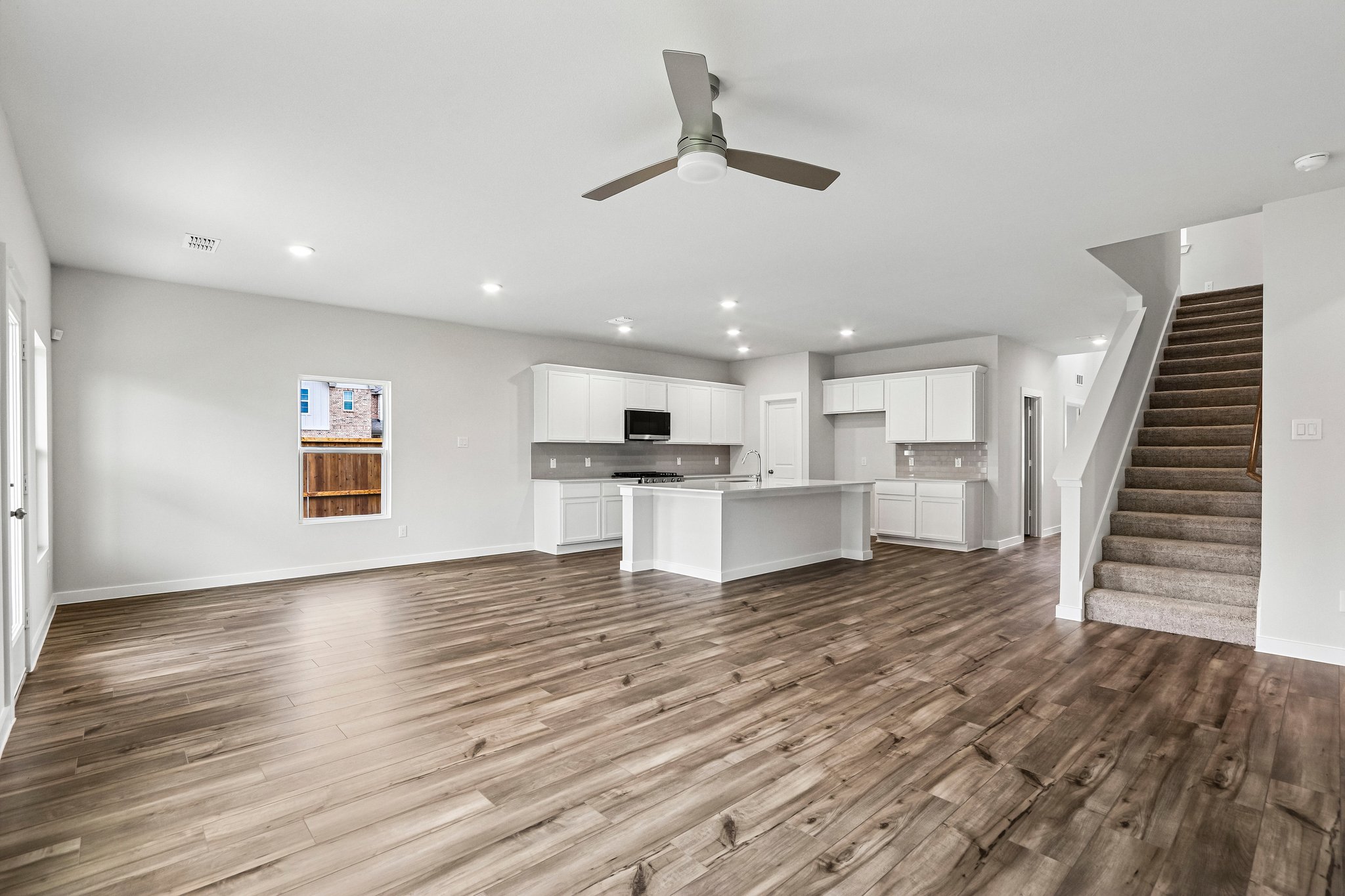 A large kitchen with wood floors.