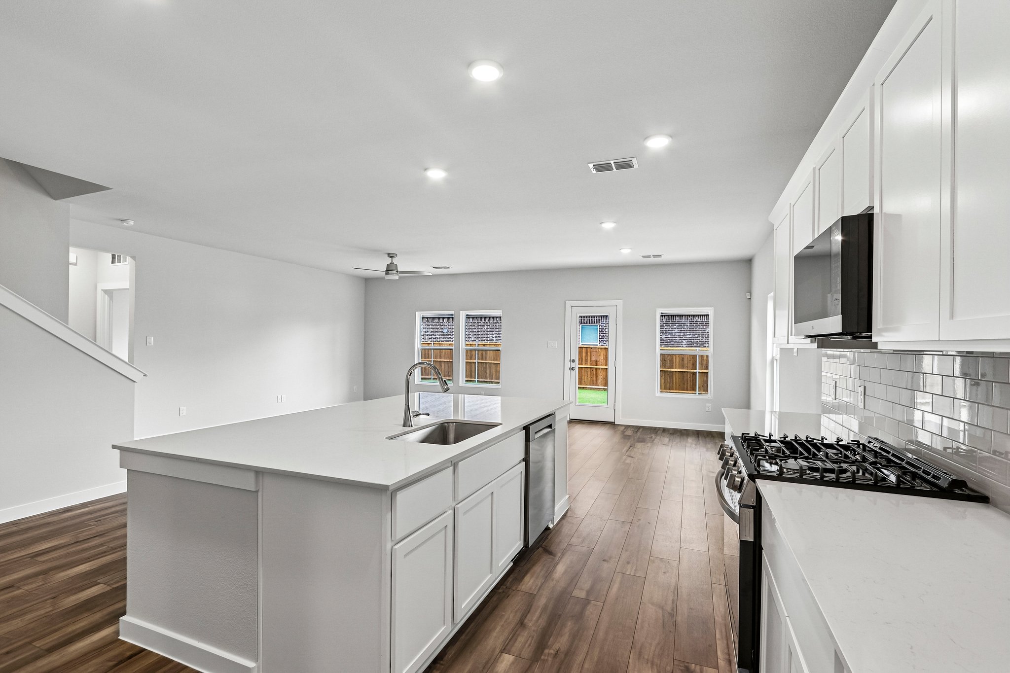 A kitchen with white cabinets.