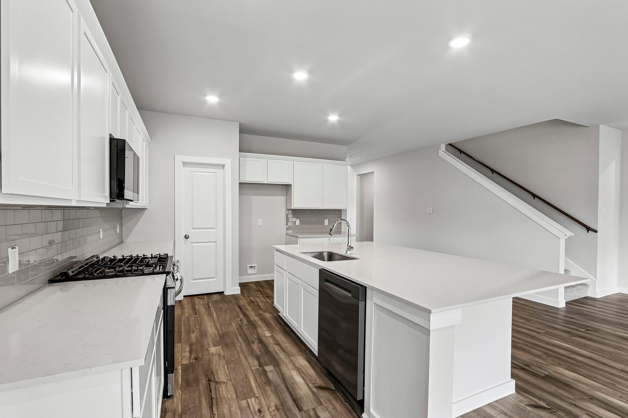 A kitchen with white cabinets.