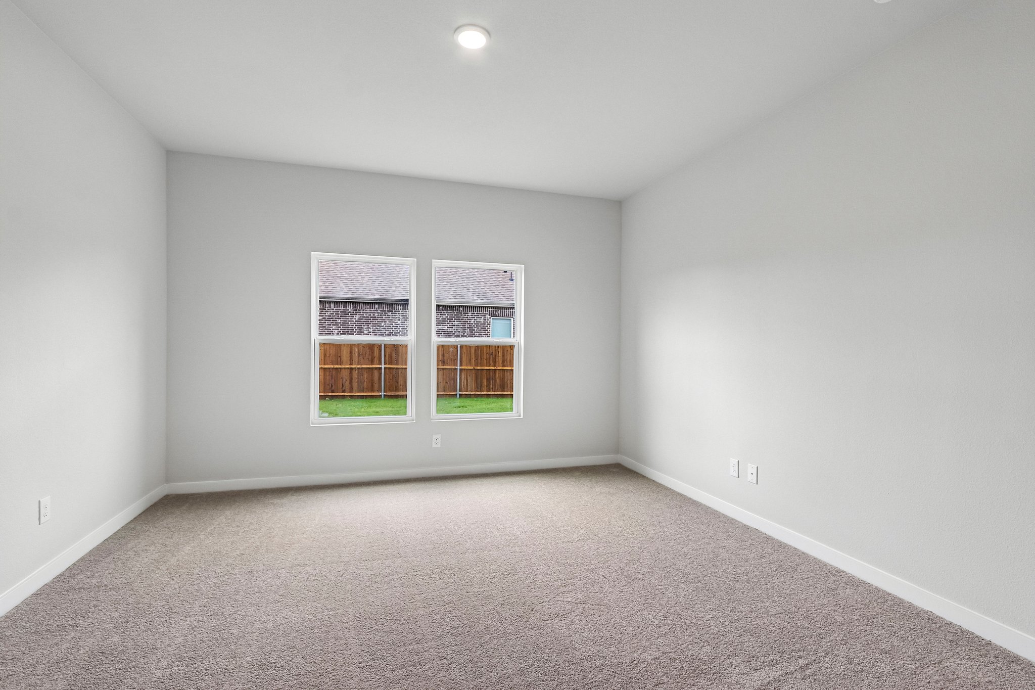 A room with a window and carpet.