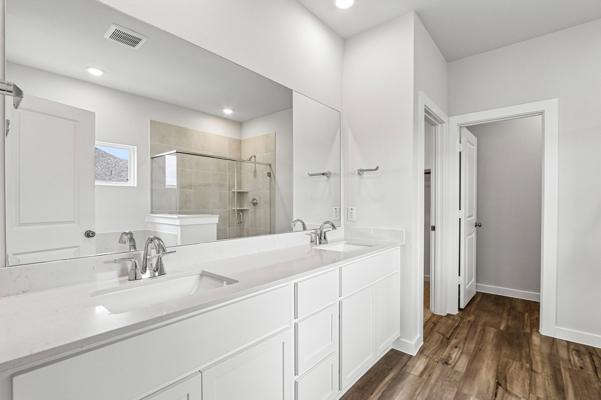 A bathroom with a large mirror.
