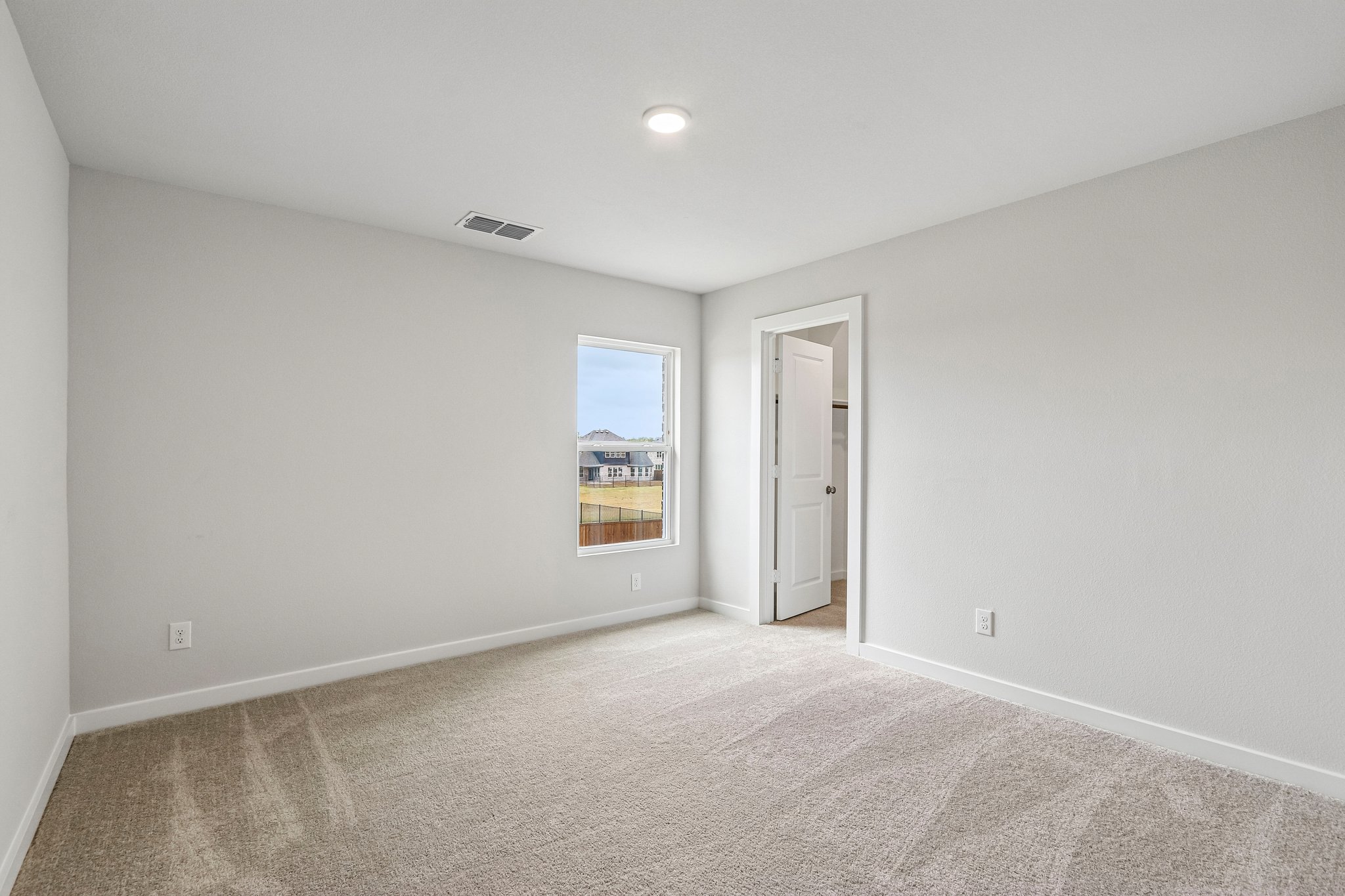 A hallway with a door and a window.