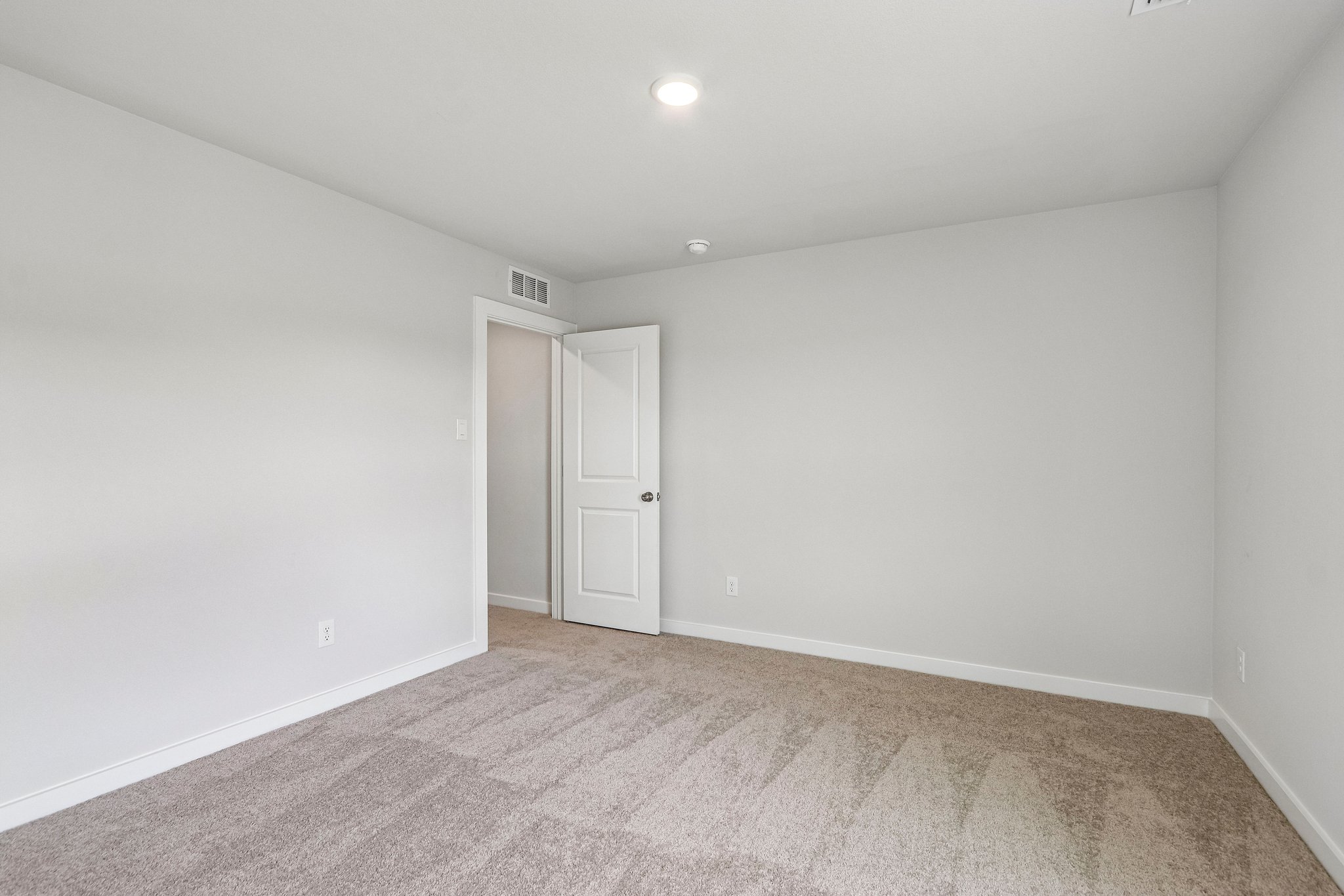 A hallway with white doors.