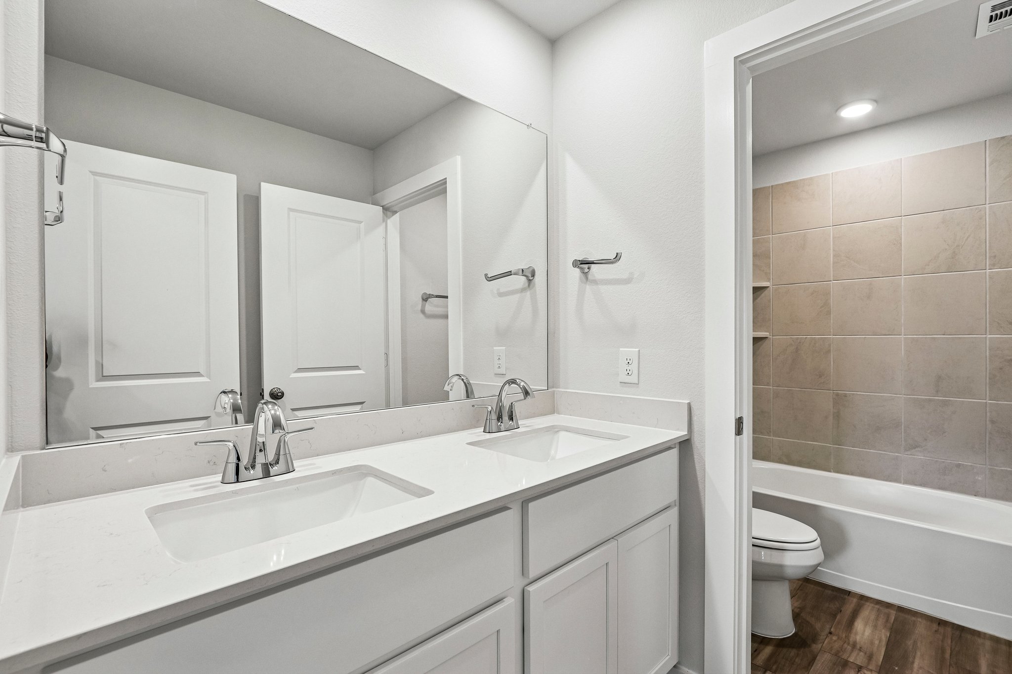 A bathroom with a tub sink and toilet.
