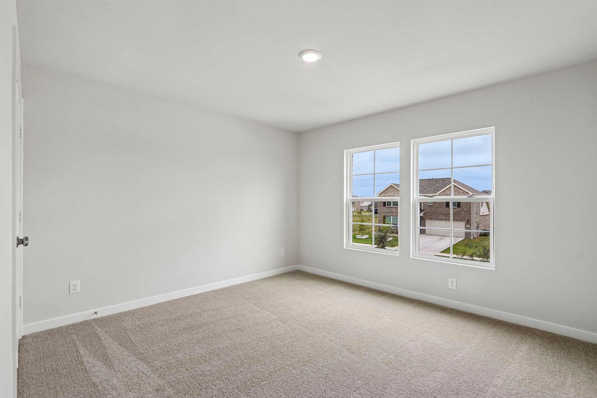 A room with a window and a carpet.