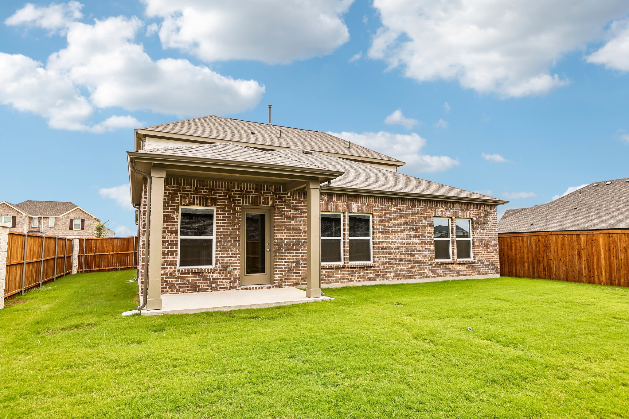A brick house with a fence.